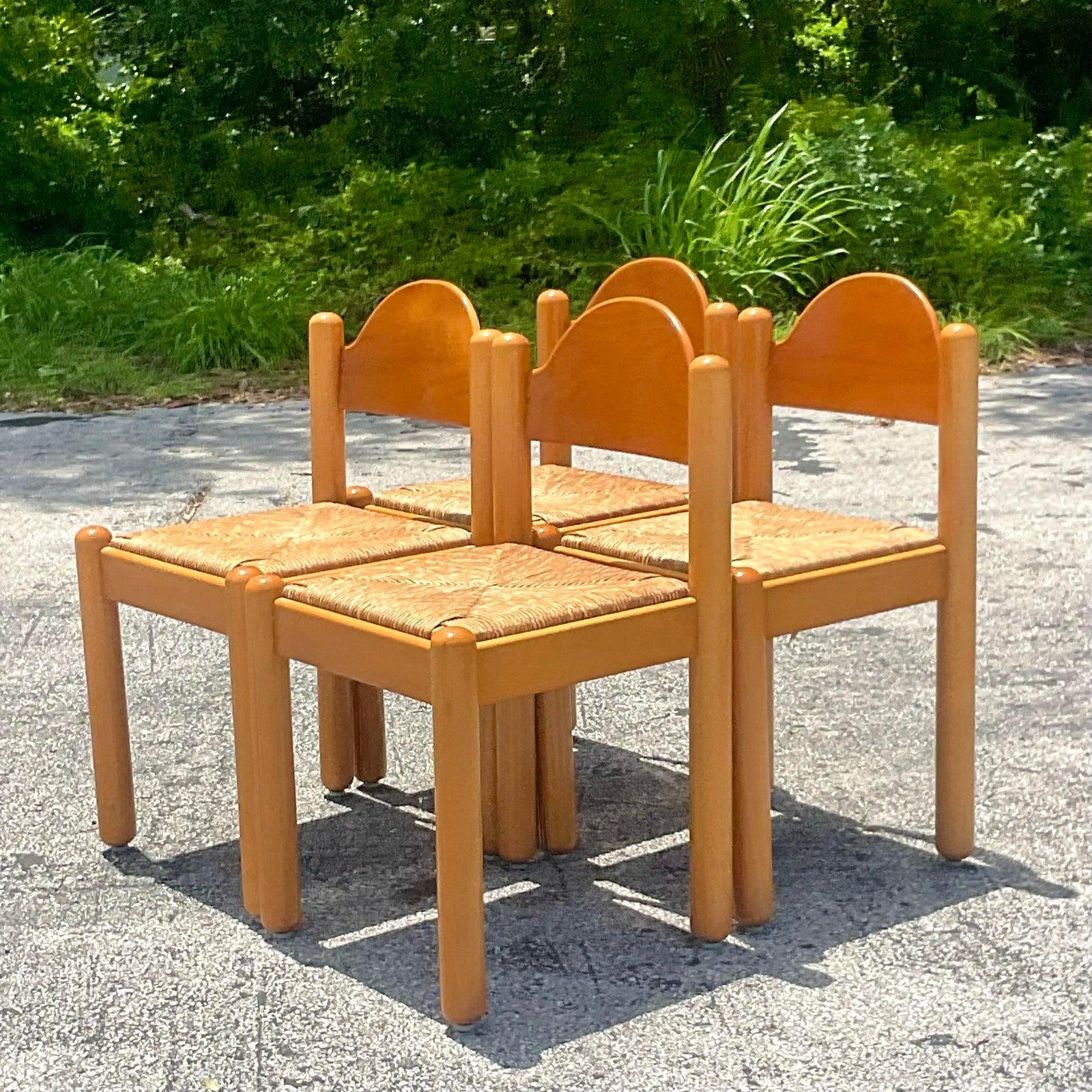 A fabulous set of 4 vintage Boho dining chairs. Done in the manner of Hank Lowenstein. The classic Padiva chair with rush seats. Marked made in Italy on the bottom. Acquired from a Palm Beach estate