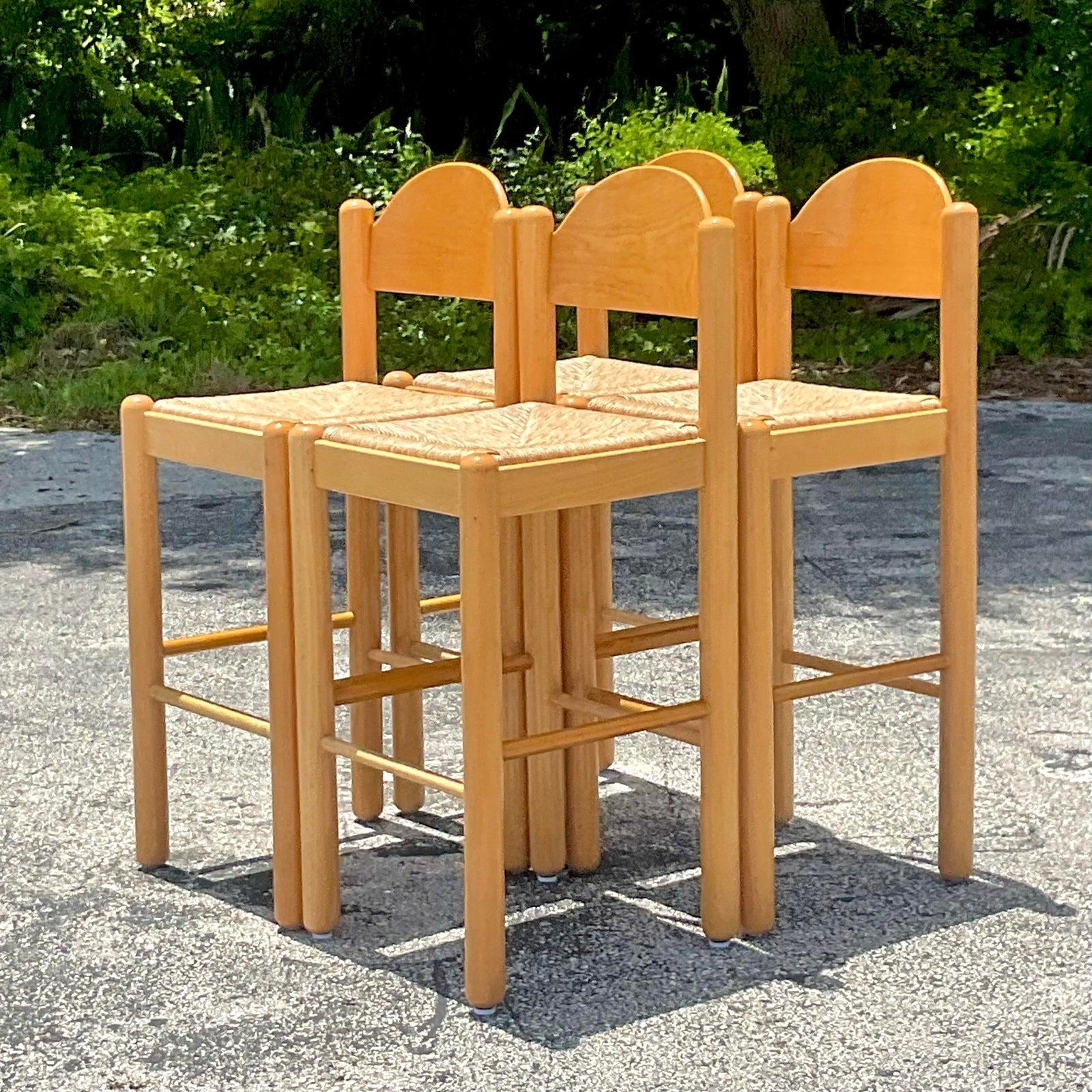 A fabulous set of four vintage Boho bar stools. Done in the manner of Hank Lowenstein. Beautiful rush seats and a clean classic design. Made in Italy. Acquired from a Palm Beach estate.