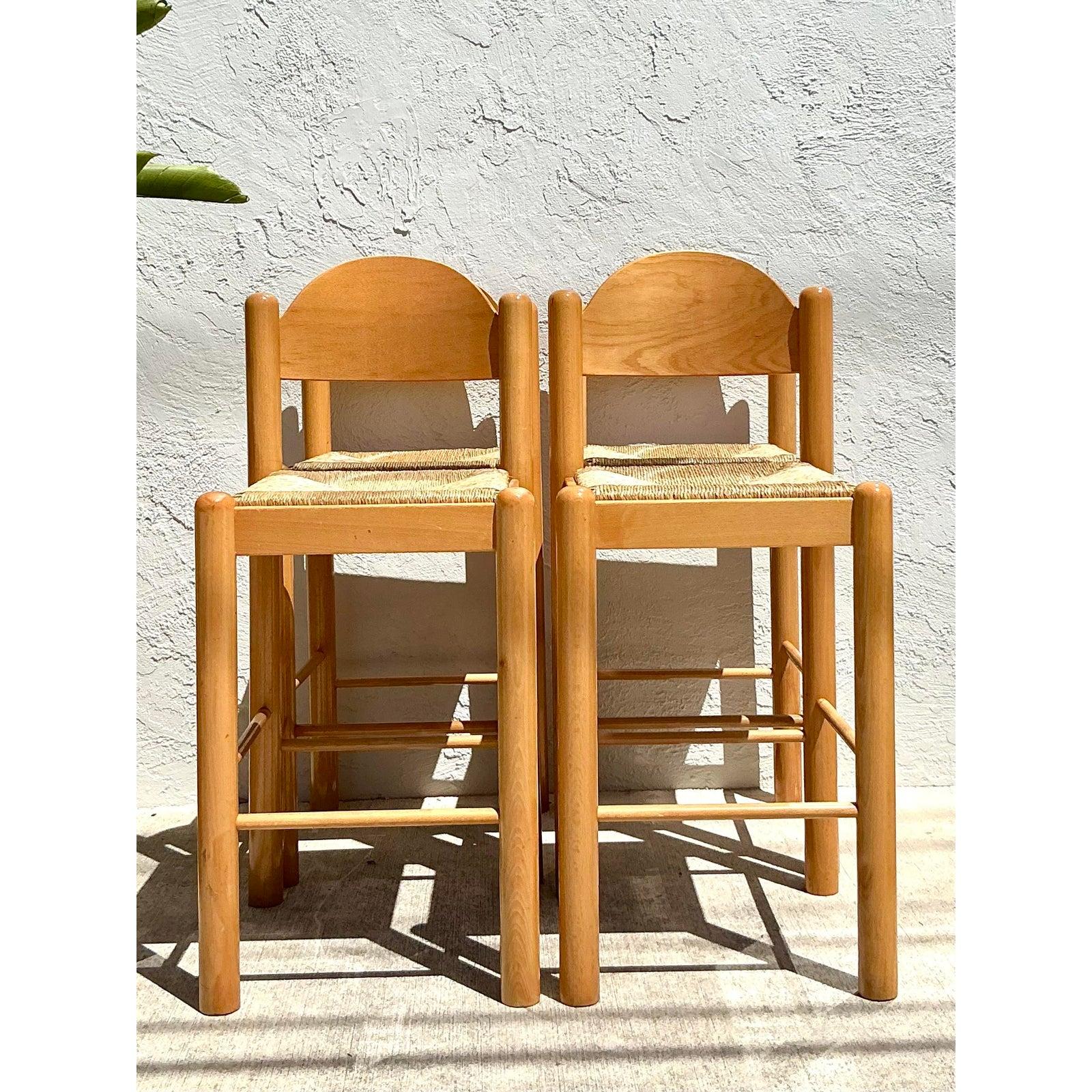 Bring the warmth of natural materials and artisanal craftsmanship into your home with this charming set of four vintage Padova stools. Crafted in Italy, these beautiful pieces feature sturdy, light-toned wooden frames with gently rounded edges and