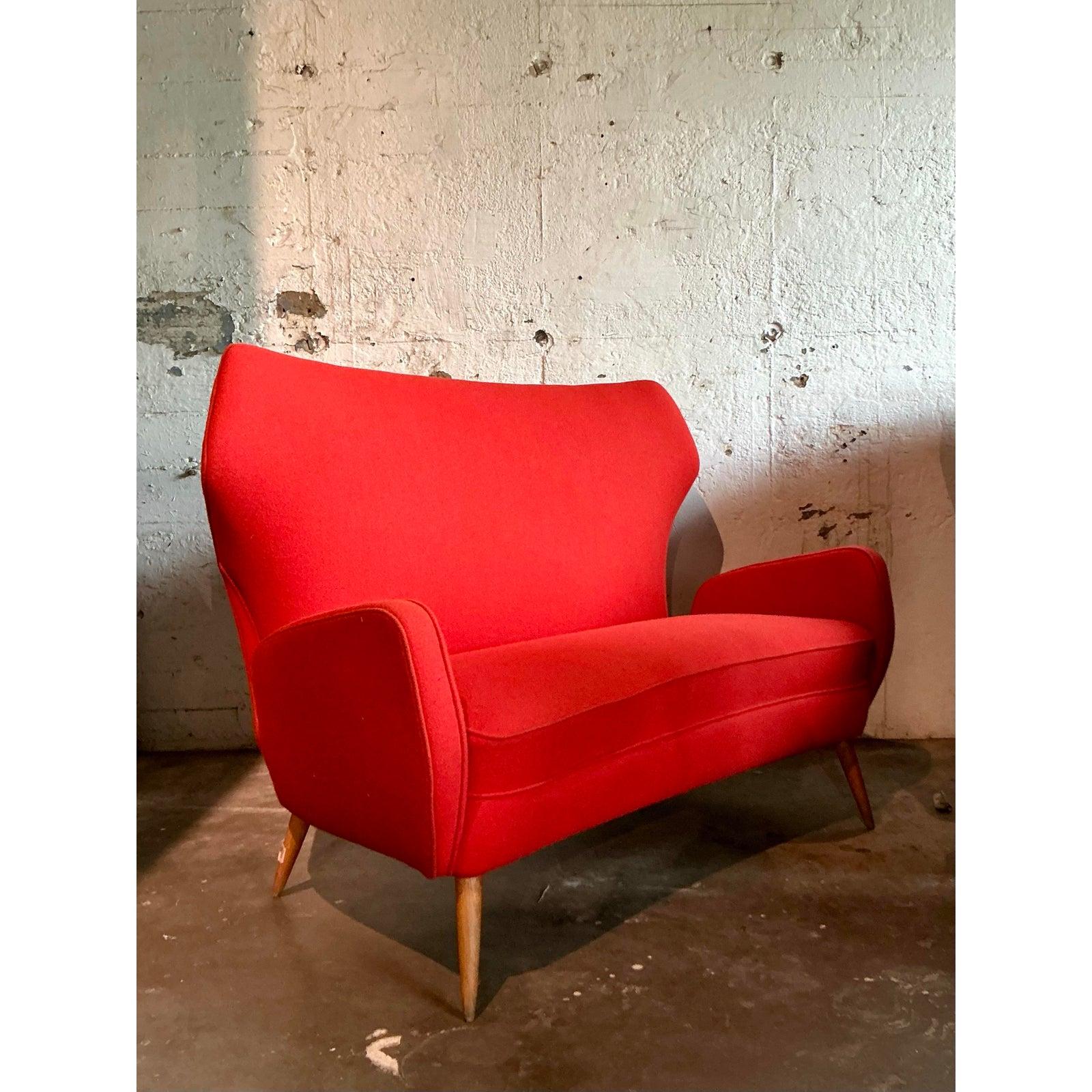 Dieses exquisite Vintage-Flügelsofa, das von den ikonischen Entwürfen von Ico Parisi inspiriert ist, verleiht Ihrem Raum einen Hauch von italienischer Raffinesse aus der Jahrhundertmitte. Dieses fesselnde Sofa ist eine meisterhafte Formstudie mit