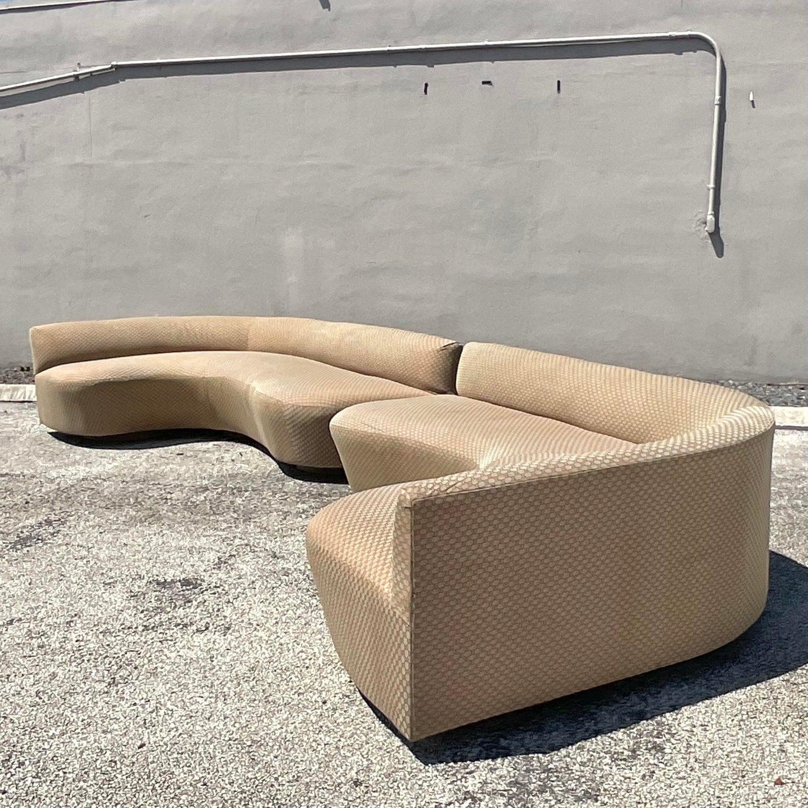 An exceptional pair of vintage Boho sofa. Custom built in a chic biomorphic shape. Great together but also work beautifully apart. Covered in a logo jacquard. The sofas come from a mansion owned by a big celebrity that was sold to an even bigger