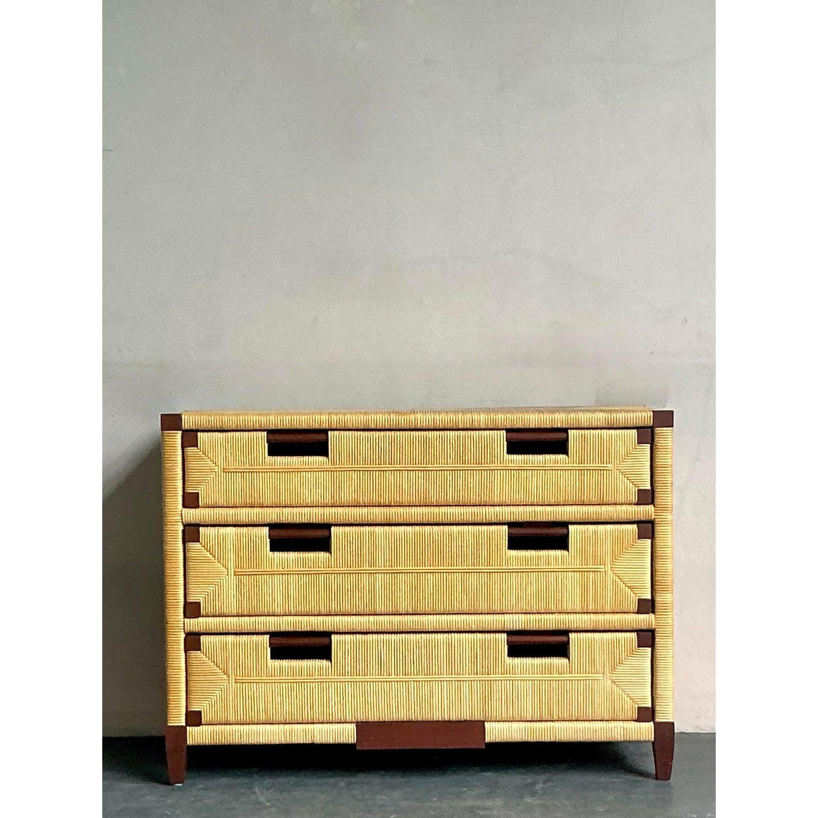 Discover this exceptional vintage Boho commode, a unique design by John Hutton for Donghia, crafted from rich mahogany and intricately woven rattan. This distinctive piece, likely from the late 20th century, beautifully blends natural materials with