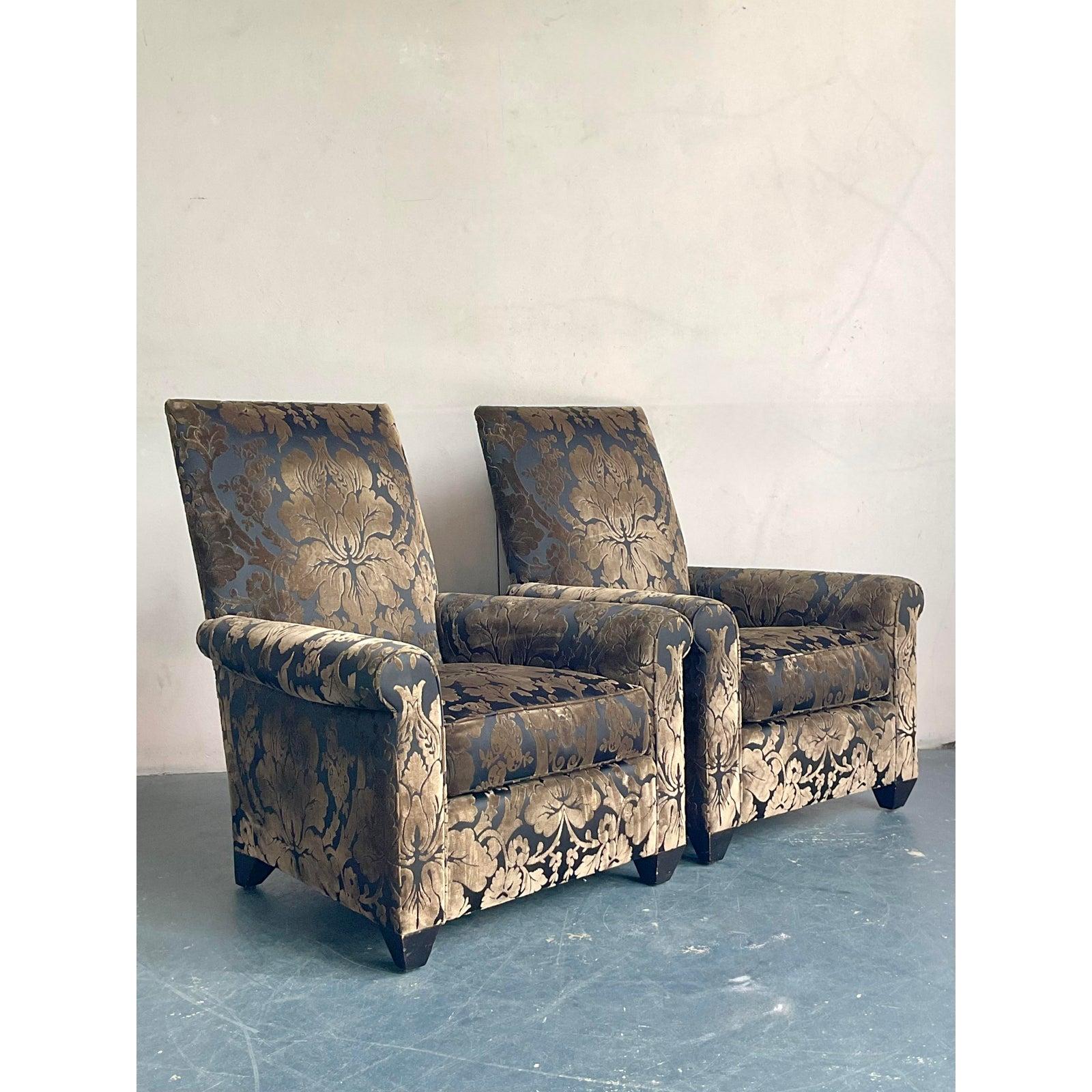 Presenting a magnificent pair of vintage lounge chairs designed by the esteemed John Hutton for Donghia, these pieces epitomize luxurious comfort and bohemian elegance. Upholstered in a sophisticated silk devoré fabric, featuring an intricate,