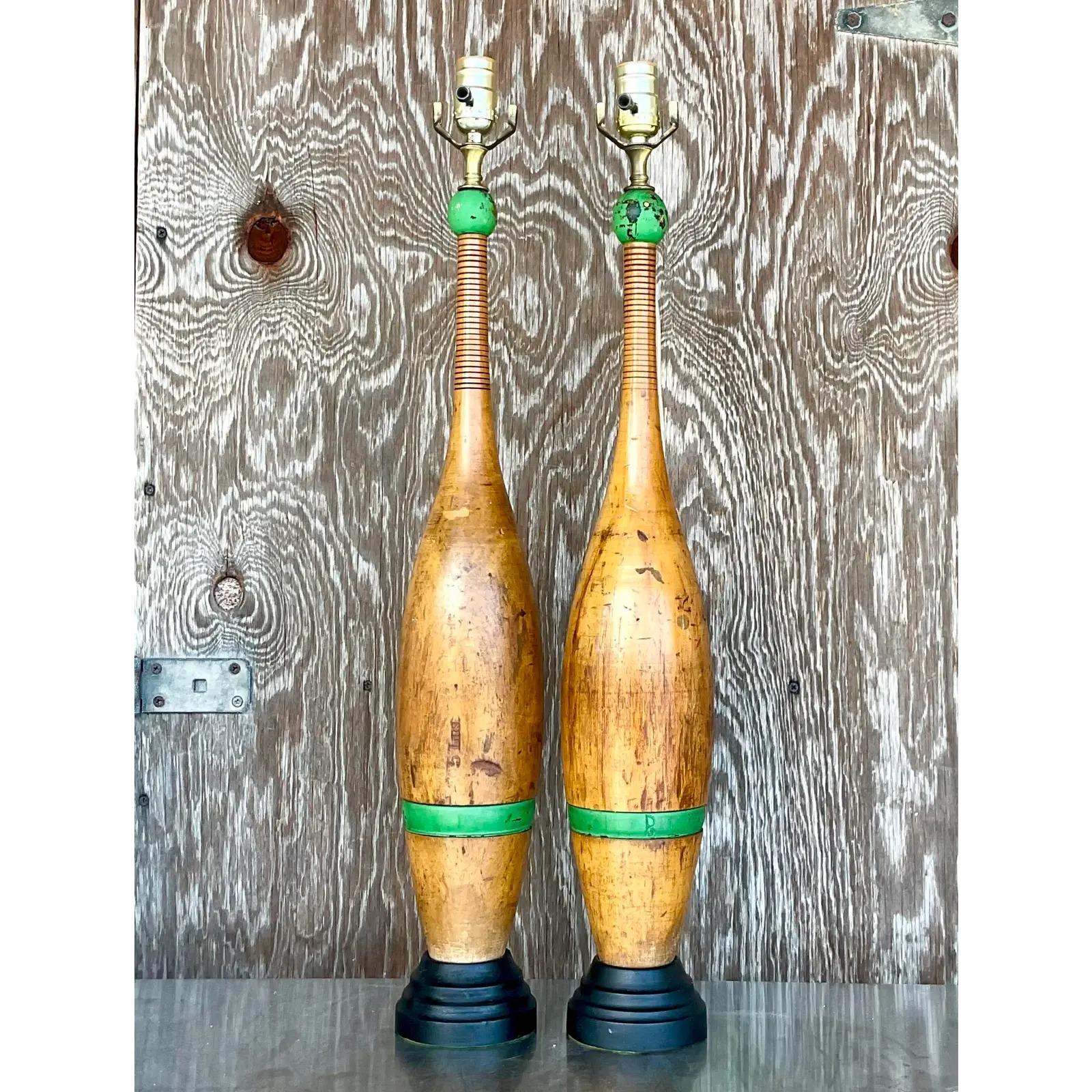 Incredible pair of vintage juggling pin lamps. Beautiful tall shape with the most beautiful patina from time. Kelly green flash at the top. Sure to add a little charm to any project. Acquired from a Naples estate.

The lamps are in great vintage