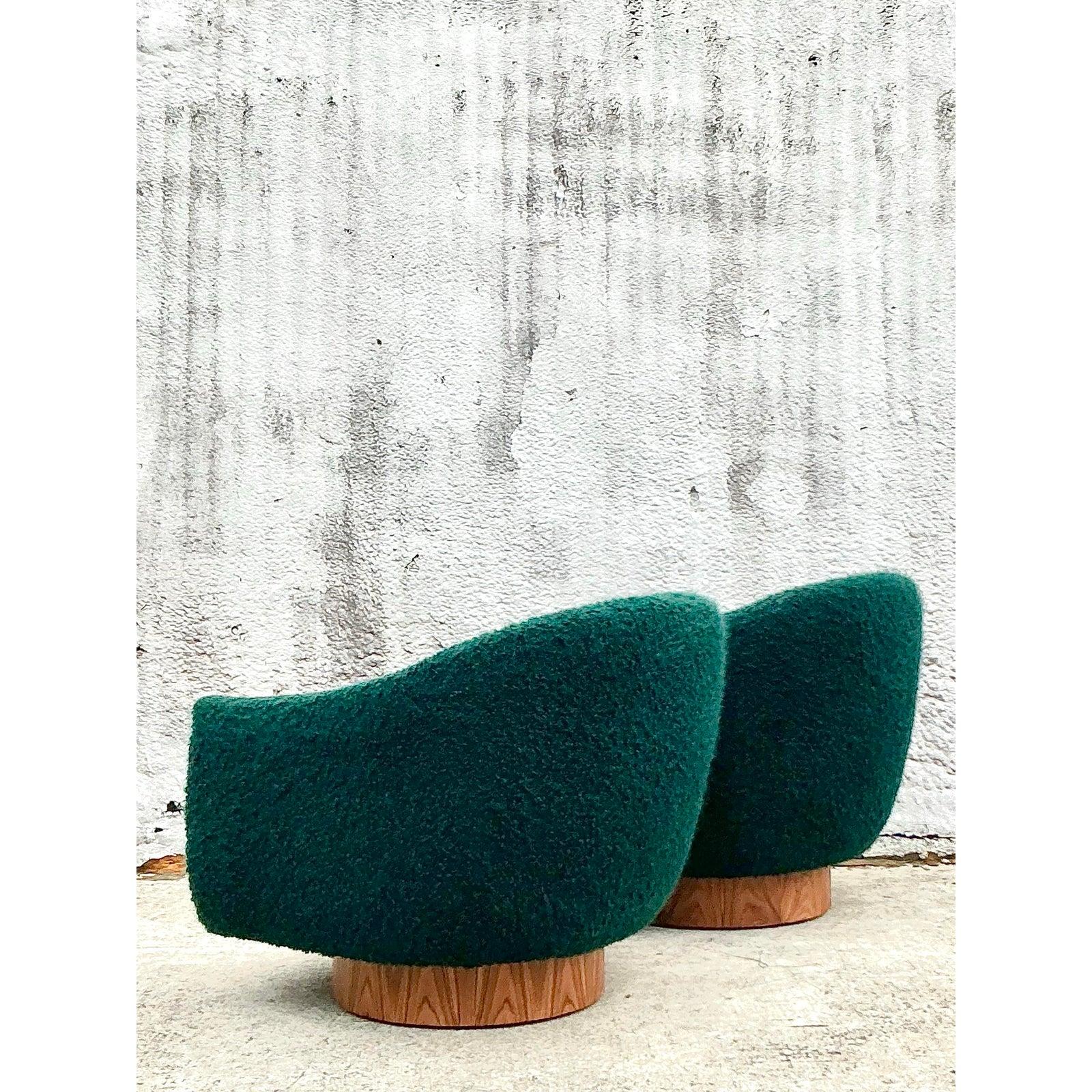 Make a bold statement with this stunning pair of vintage swivel chairs, reminiscent of the iconic Kelly Wearstler aesthetic. These sculptural lounge chairs feature a curved, enveloping silhouette that offers both supreme comfort and timeless style.