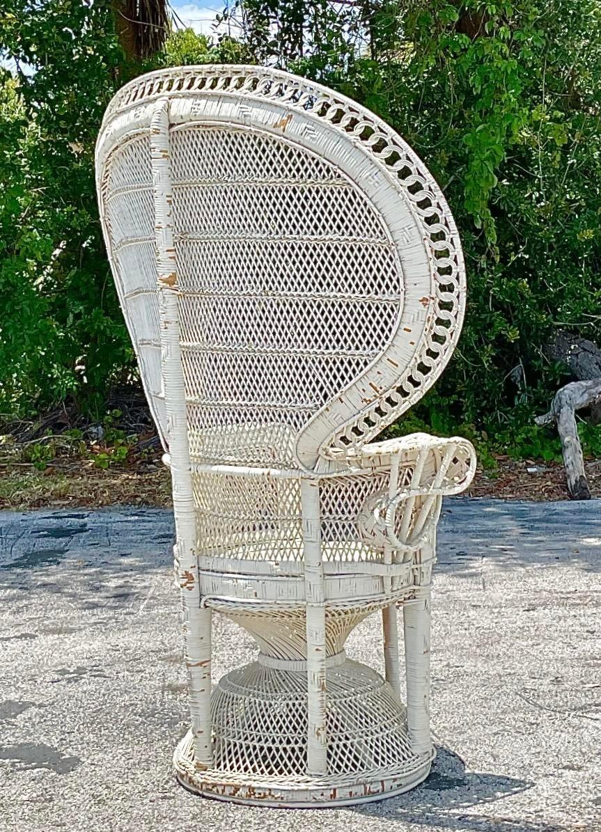 Embrace bohemian elegance with this Vintage Boho King Cobra Rattan Peacock Chair. Crafted with intricate rattan weaving and a majestic peacock-inspired silhouette, it embodies the free-spirited essence of American style. Make a statement with this