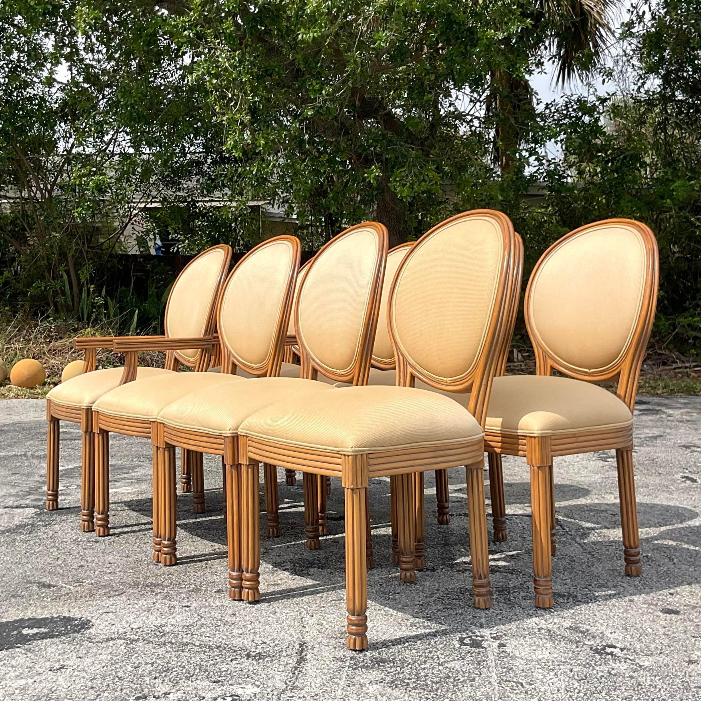 A fabulous set of 8 vintage Boho dining chairs. Made by the iconic Kreiss Collection and tagged below the seat. Beautiful hand carved detail with a medallion back shape. Acquired from a Palm Beach estate.

Side chairs 21.5 