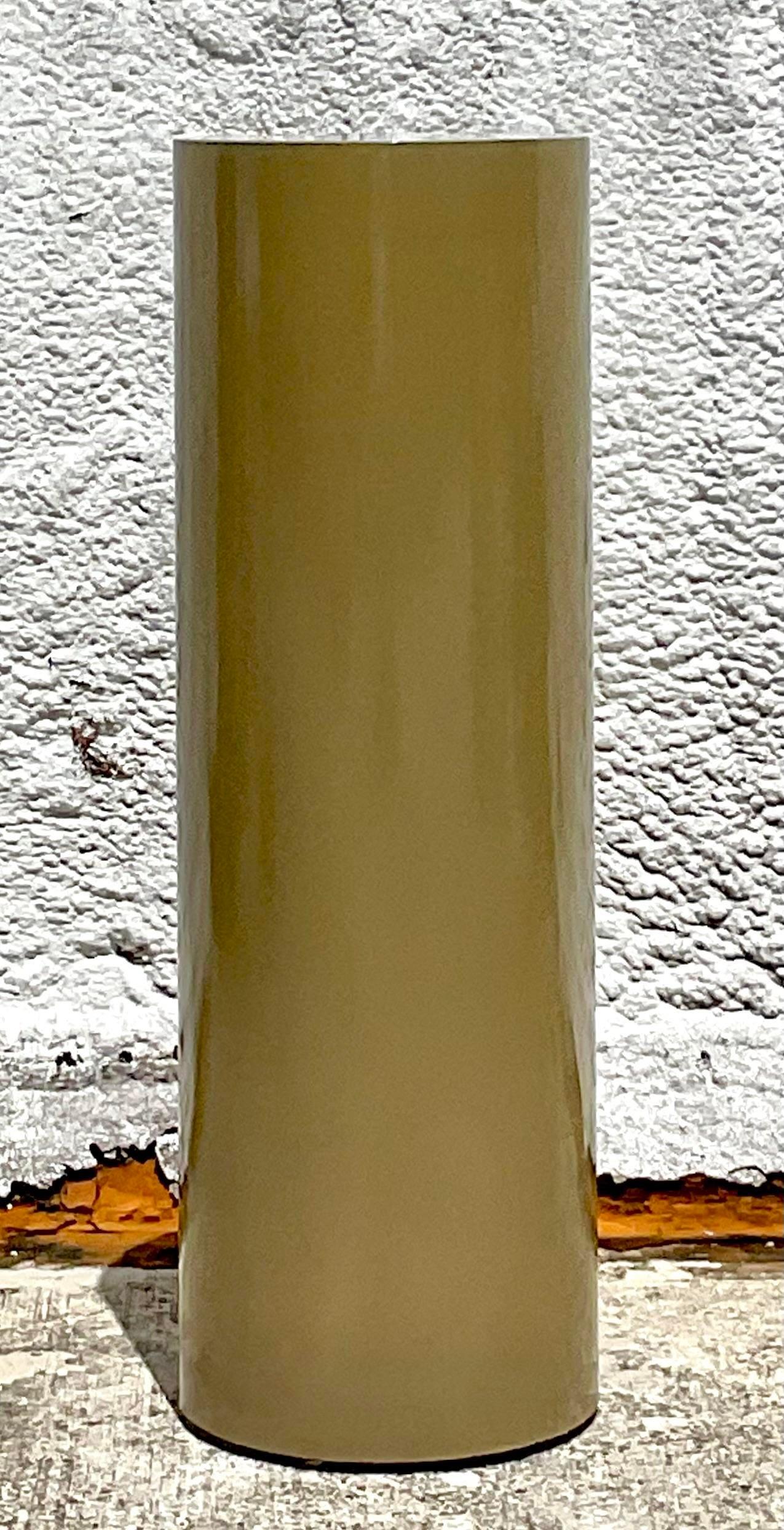 A fantastic vintage boho pedestal. A beautiful pale olive green in a lacquered finish. A chic cylinder shape makes it an easy addition to any project. Acquired from a Palm Beach estate.