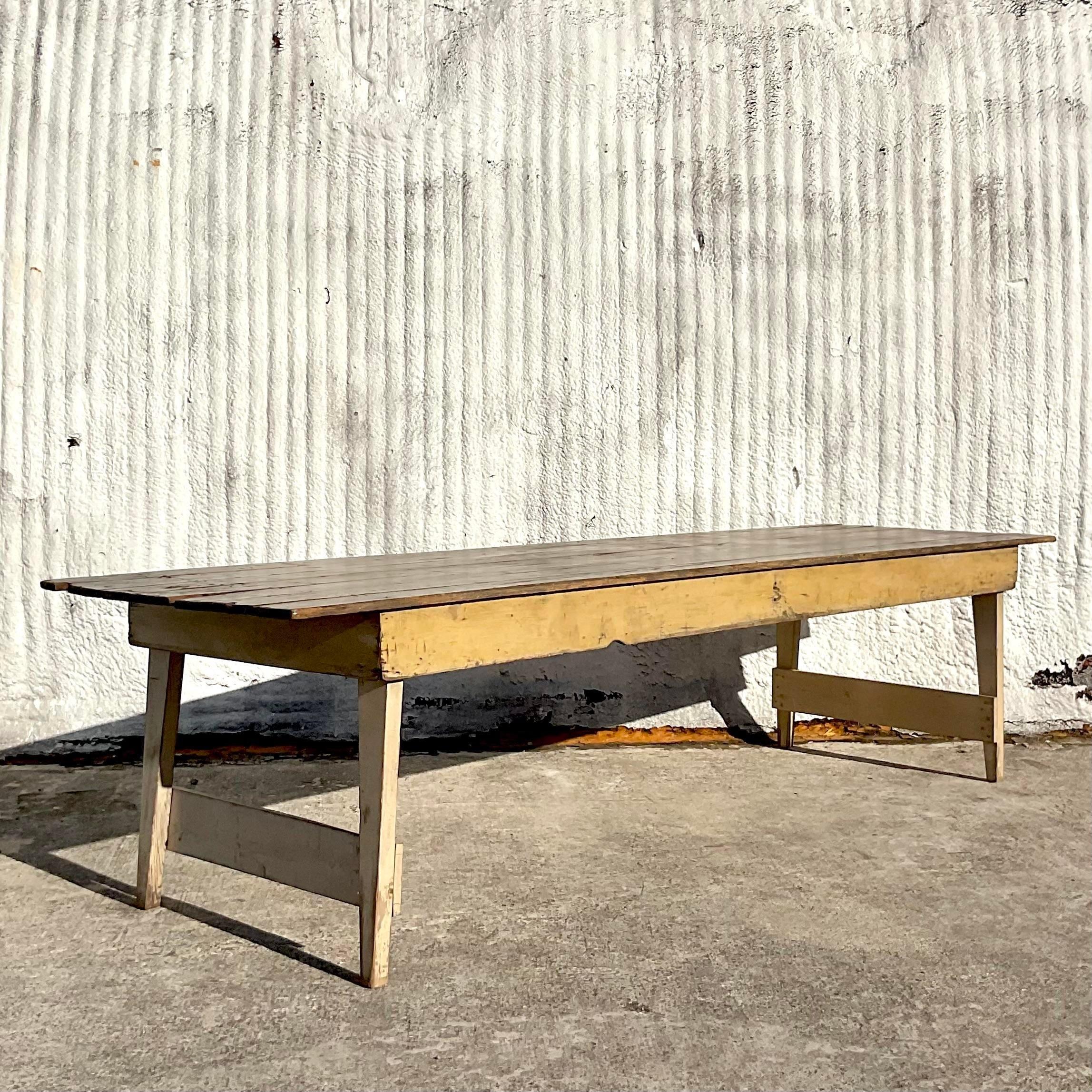 An exceptional vintage Harvest farm table. Gorgeous hand chamfered plank top with distressed apron and splayed legs. Monumental in size and drama. 10 coordinating chairs also available on my page. Acquired from a Historical Florida estate.