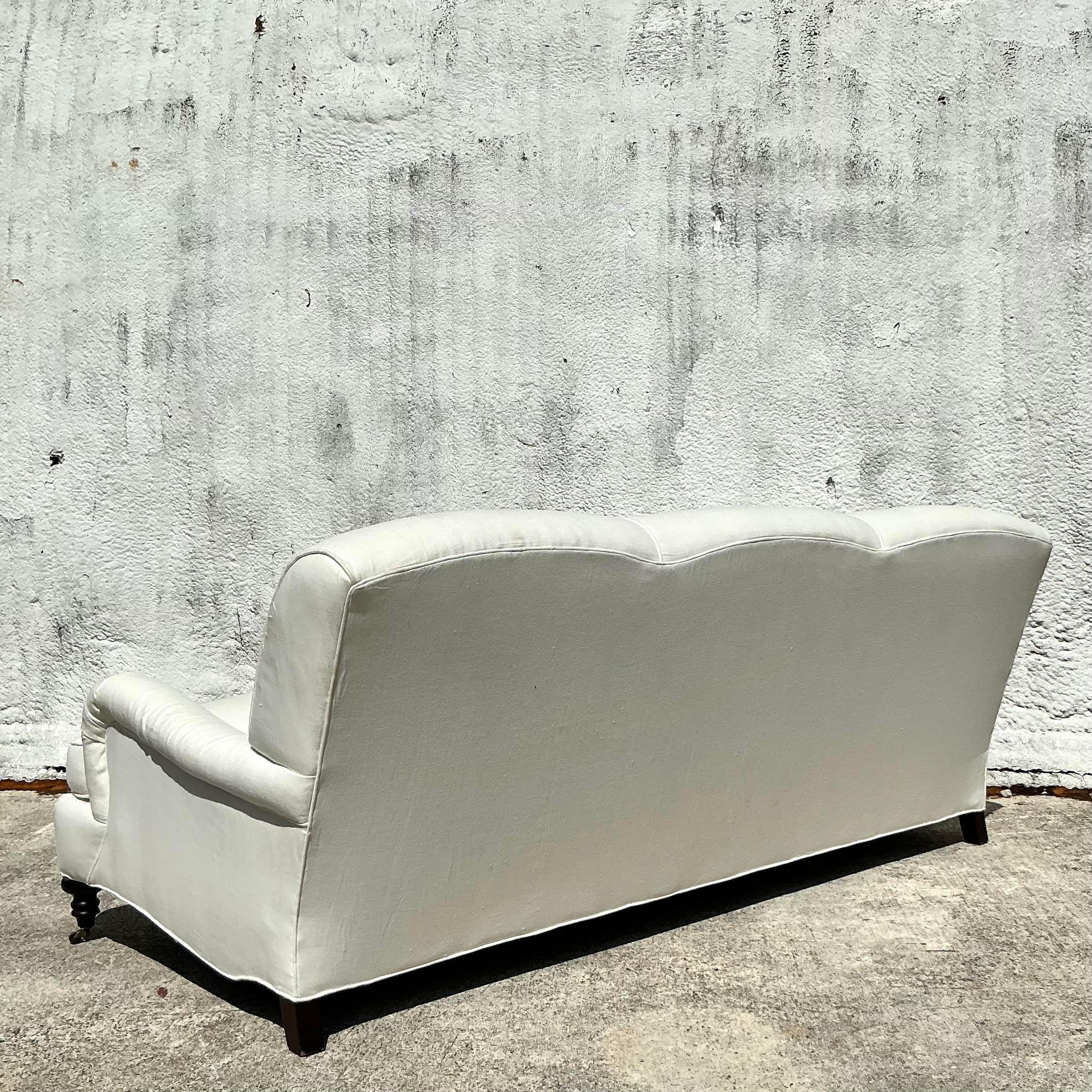 Introducing our Vintage Boho Lee Industries English Roll Arm Sofa, an elegant blend of classic design and American bohemian flair. This exquisite sofa features timeless English roll arms and plush cushions, offering both style and comfort.