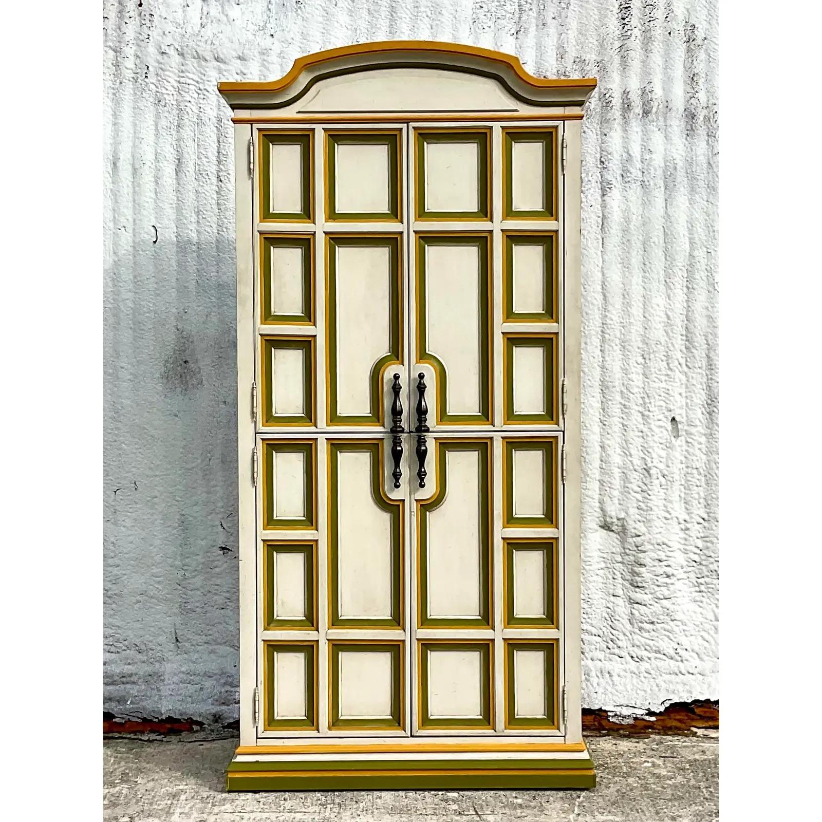 A fabulous vintage Boho tall armoire. Beautiful lemonlime two tone Millwork. Lots of great storage and drawers inside. Acquired from a Palm Beach estate.
