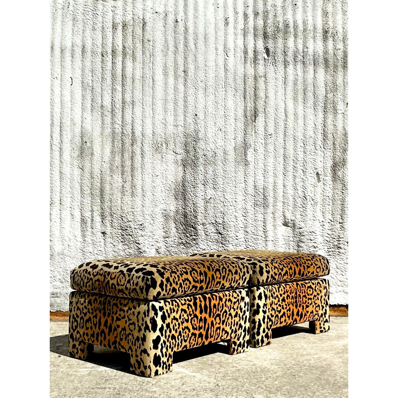 Unleash bold sophistication with this striking pair of vintage leopard velvet ottomans. Upholstered in luxurious, plush velvet with a vibrant leopard print, these ottomans exude a glamorous, bohemian charm that brings energy to any space. The