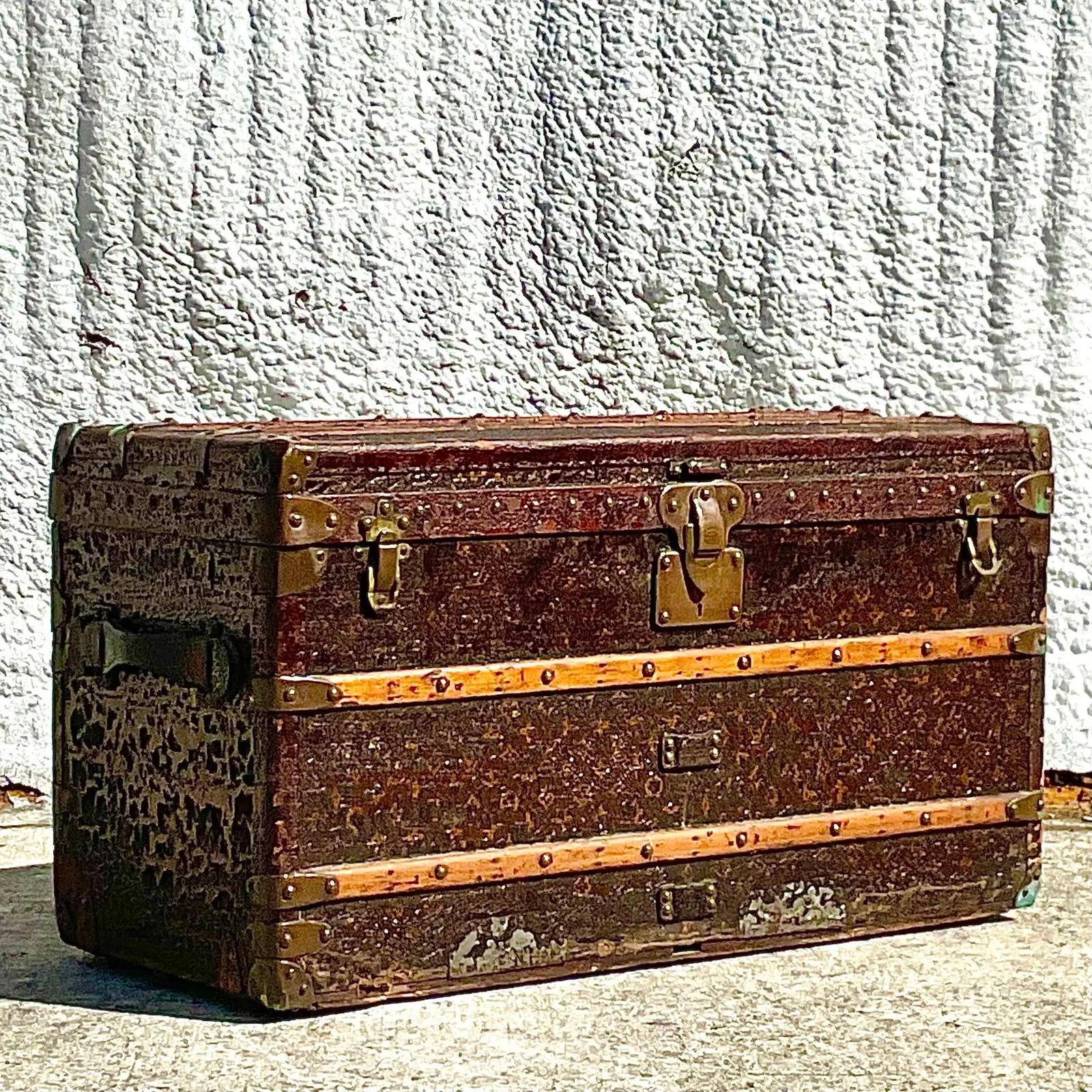 A spectacular vintage Boho Steamer trunk. Made by the prestigious Louis Vuitton group. All over patina from time and use. This is a well loved trunk! Marked on the lock. Three interior stacking shelves. Acquired from a Palm Beach estate.

The
