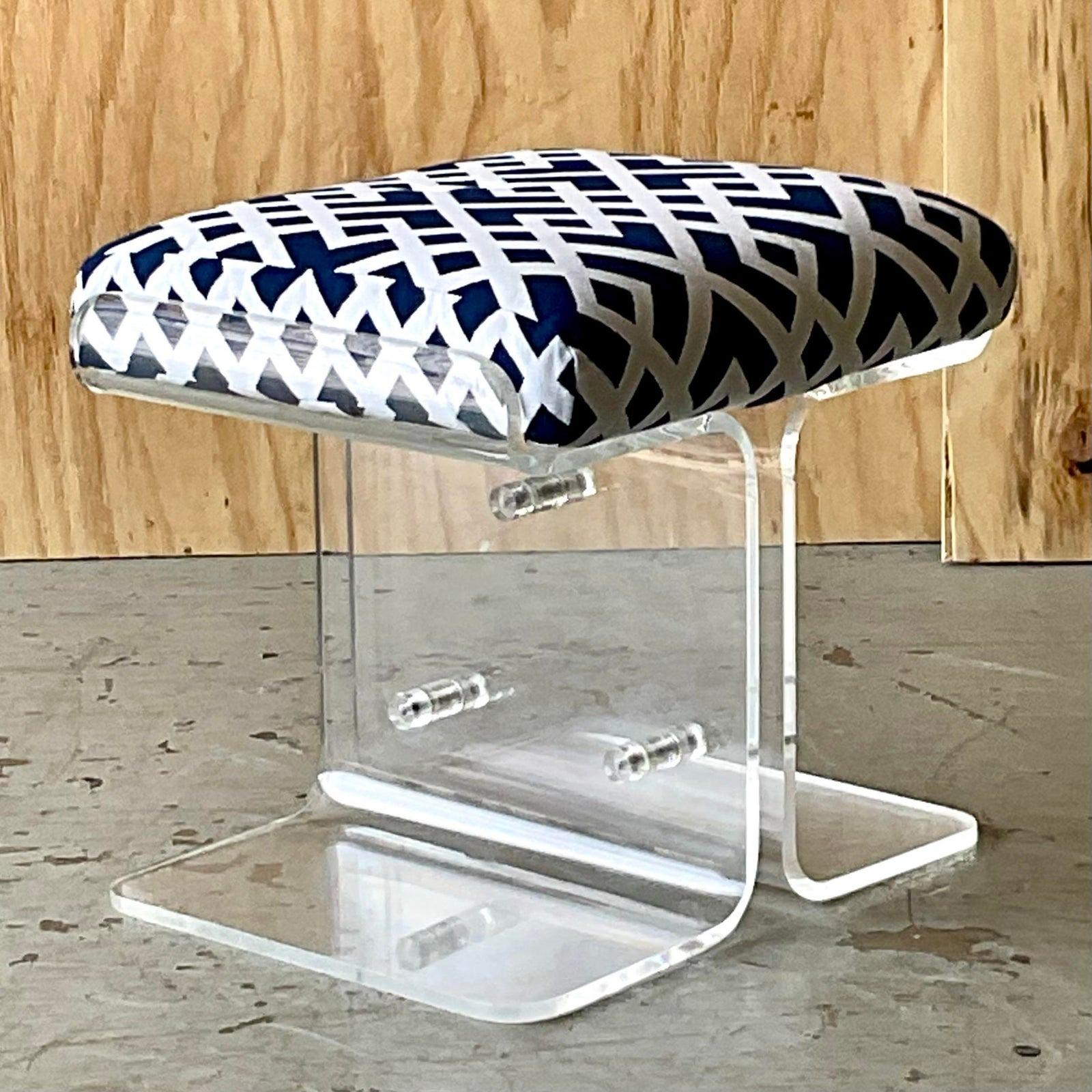 Vintage Boho lucite and chrome vanity bench. A chic molded curve with heave chrome rivets. 
 Gorgeous Hollywood Regency Fretwork printed upholstery. Acquired from a Palm Beach estate.