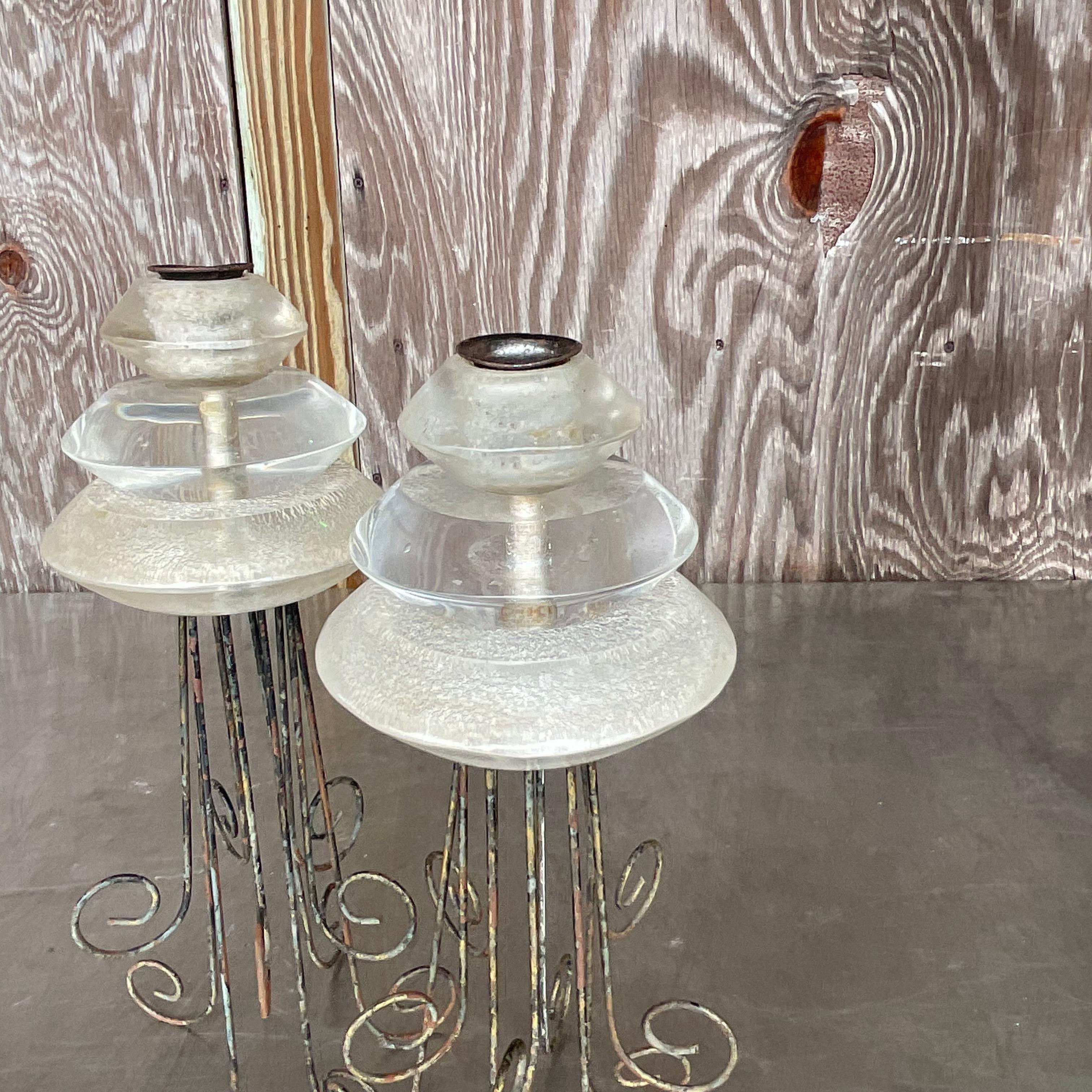 Illuminate your space with a dash of Bohemian elegance and modern flair. This vintage set of Lucite and metal scroll candlesticks adds a touch of sophistication to any room. With their unique combination of materials and intricate design, they