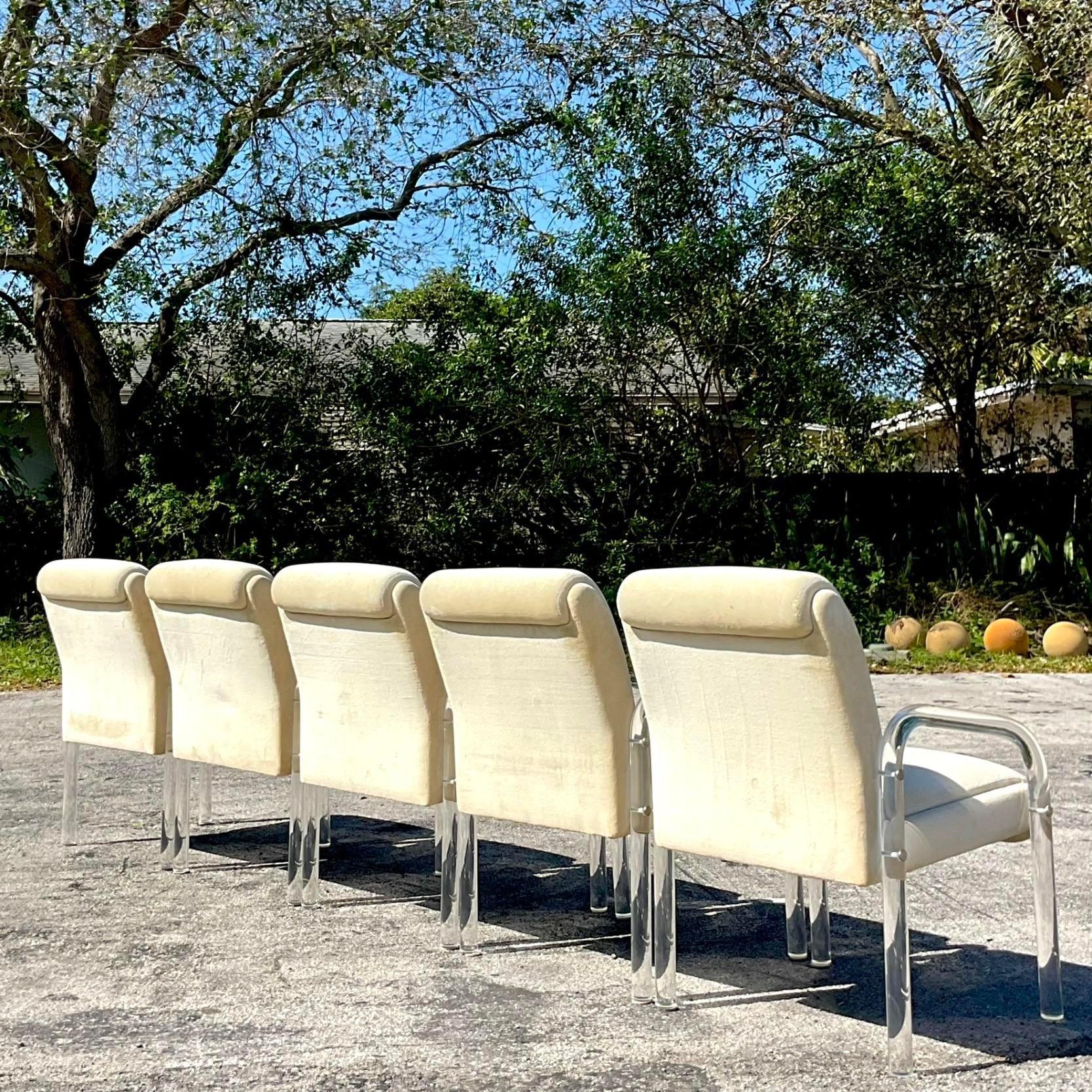 A fantastic set of six vintage 20th Century dining chairs. Done in the manner of Leop Russell for Pace. Beautiful arched lucite arms on a clean modern upholstered seat. Acquired from a Palm Beach estate.