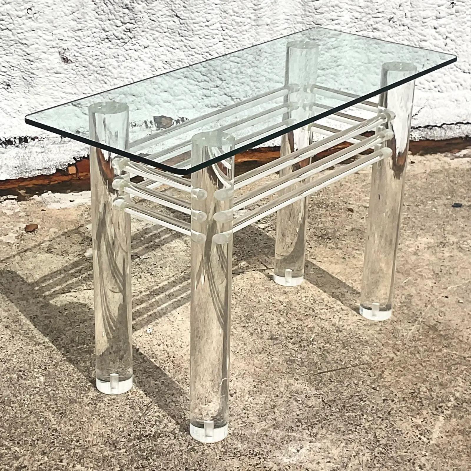 A stunning vintage Contemporary console table. A chic lucite cylinder frame with a ring of lucite rods around the perimeter. Glass top rests on frame. Acquired from a Palm Beach estate.