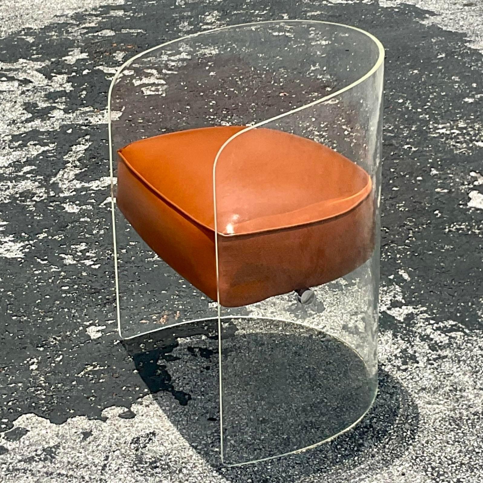 A fabulous vintage Boho Tub chair. A chic lucite body with a floating seat. Newly reupholstered in a caramel leather. Chrome hardware. Done in the manner of Vladimir Kagan. Acquired from a Palm Beach estate.