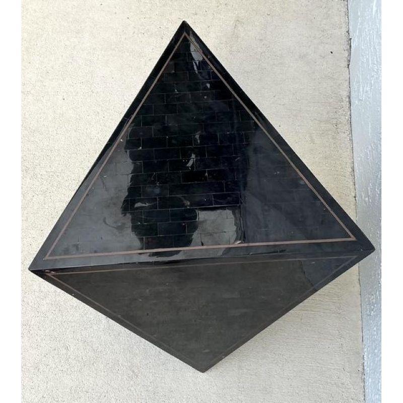 Make a striking statement with this vintage Maitland Smith tessellated stone triangle side table, an exceptional piece that perfectly blends bohemian allure with sophisticated design. Crafted with meticulous attention to detail, this table features