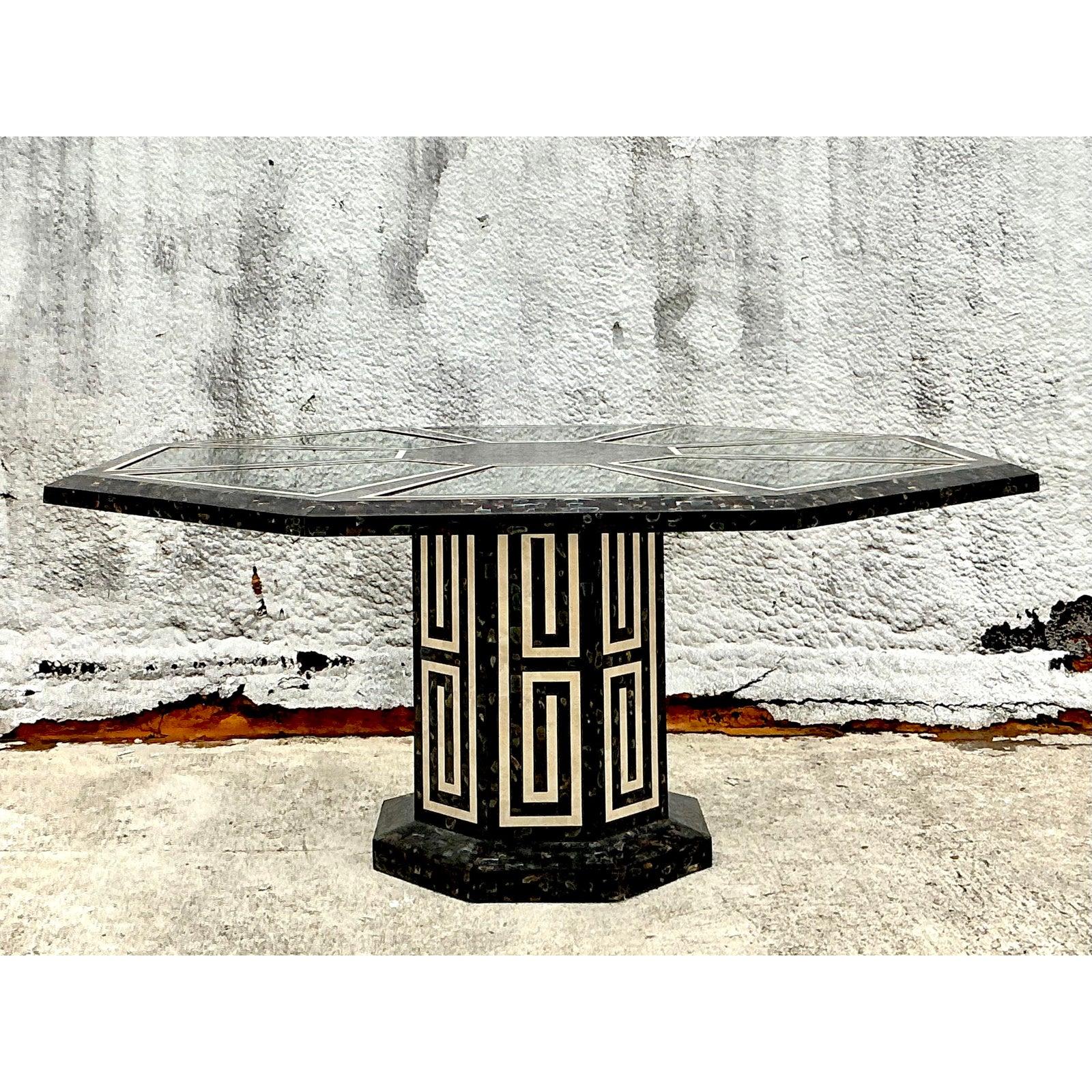 Command attention with this extraordinary Vintage Maitland Smith Tessellated Octagon Dining Table, a magnificent embodiment of opulent design and exquisite artisan craftsmanship. This impressive table features a breathtaking surface meticulously