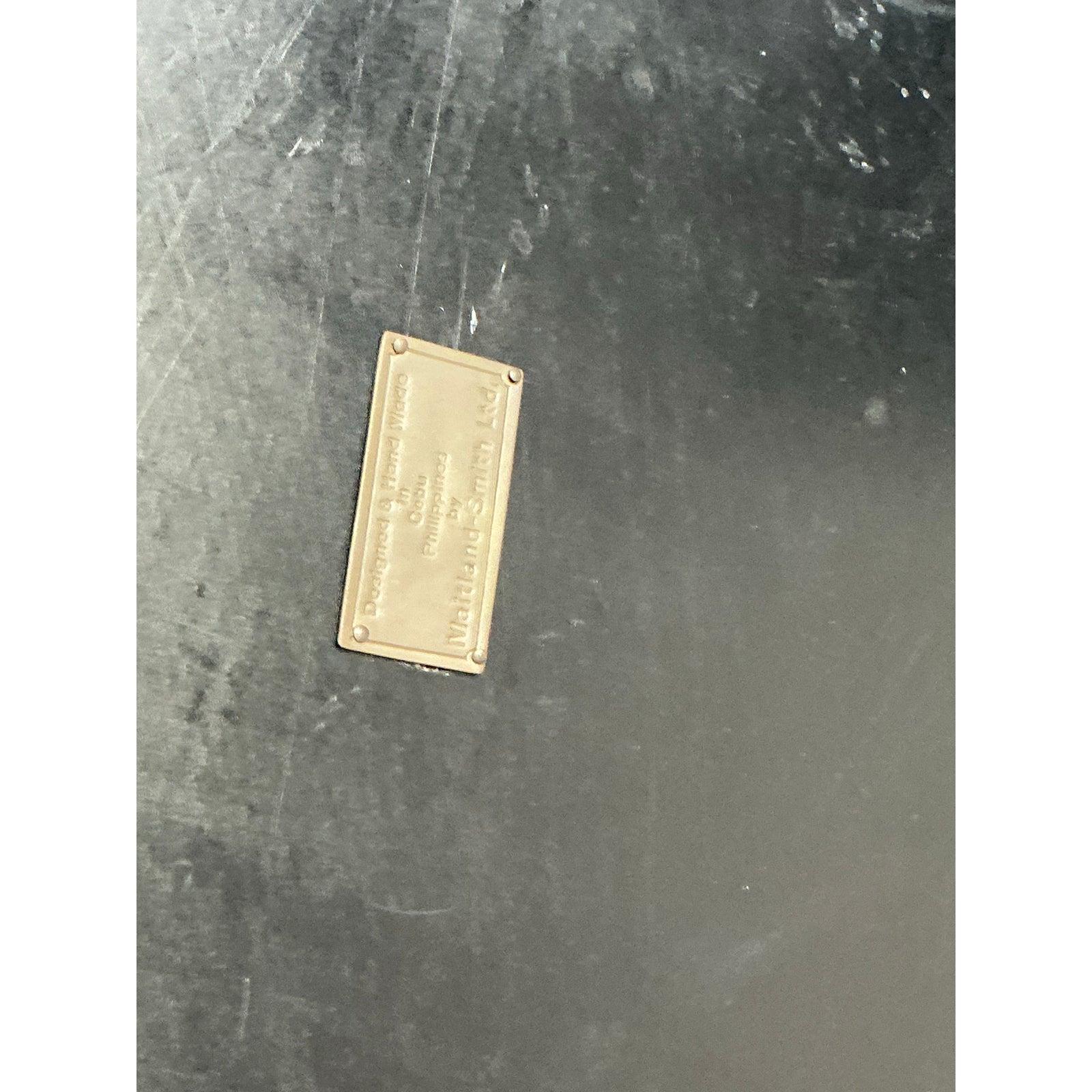 This spectacular cabinet is an uncompromising example of high-end, Postmodern design, strongly influenced by artisans specializing in exotic materials like Maitland-Smith. The entire surface is covered in a highly dynamic tessellated inlay, composed