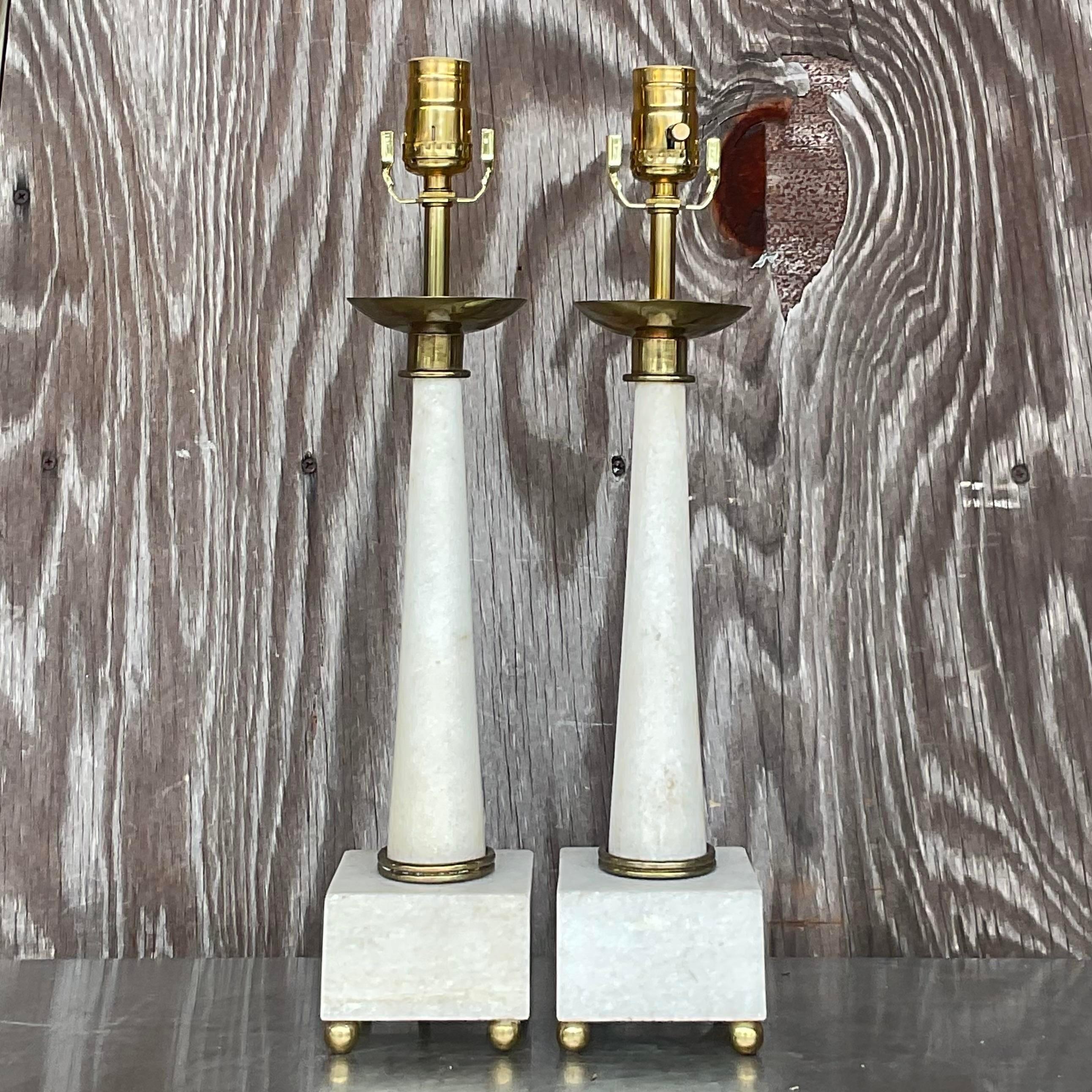 A fabulous pair of vintage Boho table lamps. Done in the manner of thr iconic Tommi Parzinger. Chic marble frame with period brass accents. Acquired from a Palm Beach estate.