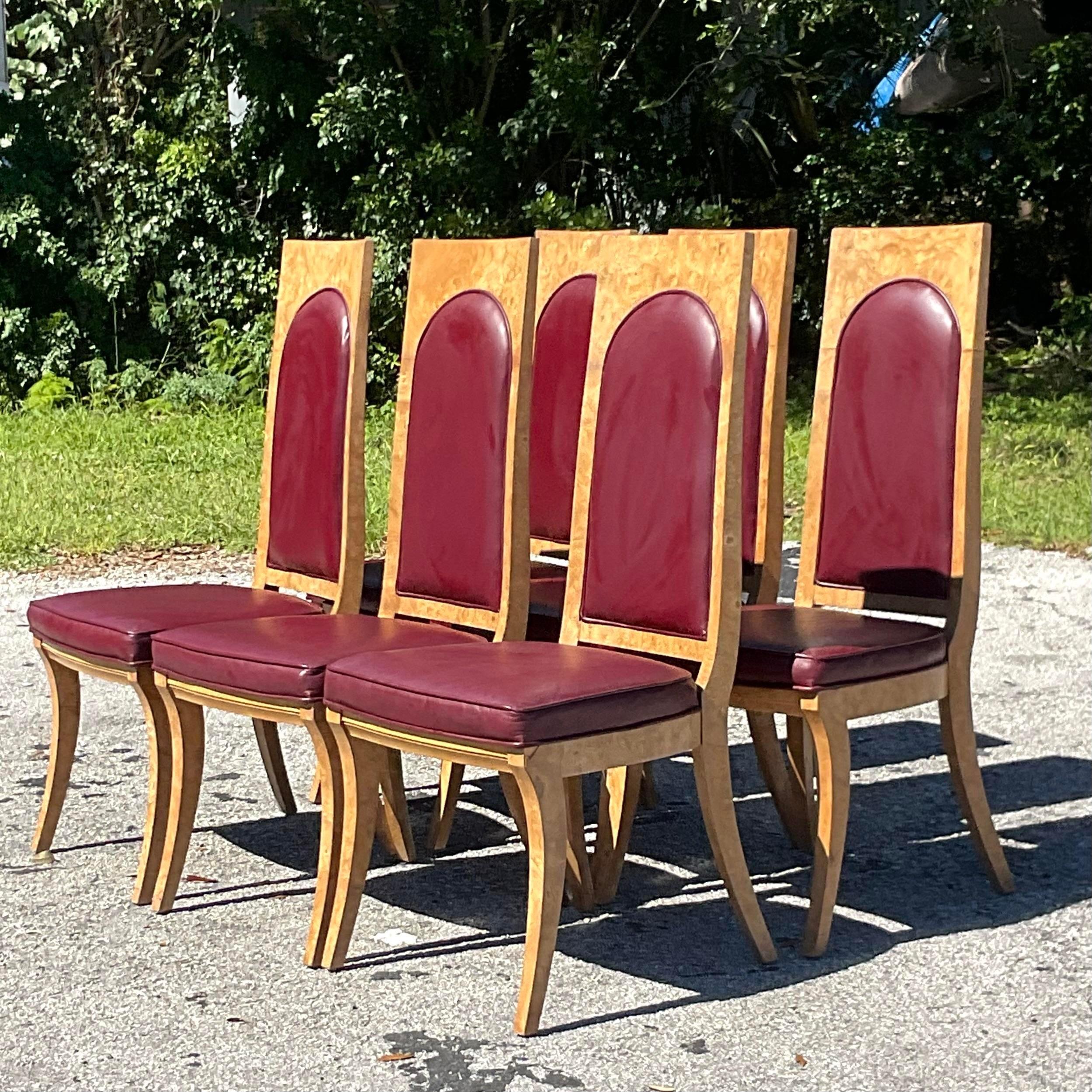 A fabulous set of sic vintage Boho dining chairs. Made by the iconic Mastercraft group. Unmarked. A chic saber leg and Aboyna Burl wood frame. Inset faux leather upholstery. Acquired from a Palm Beach estate.