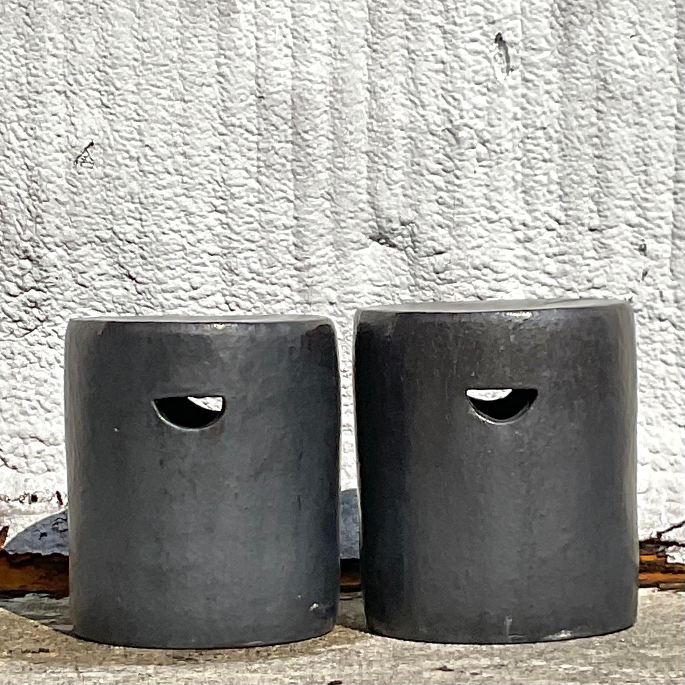 A fabulous pair of vintage Boho low stools. Chic matte glazed ceramic in a dark charcoal color. Perfect indoors or outside. A clean contemporary design with half moon cutouts for handles. Acquired from a Palm Beach estate.