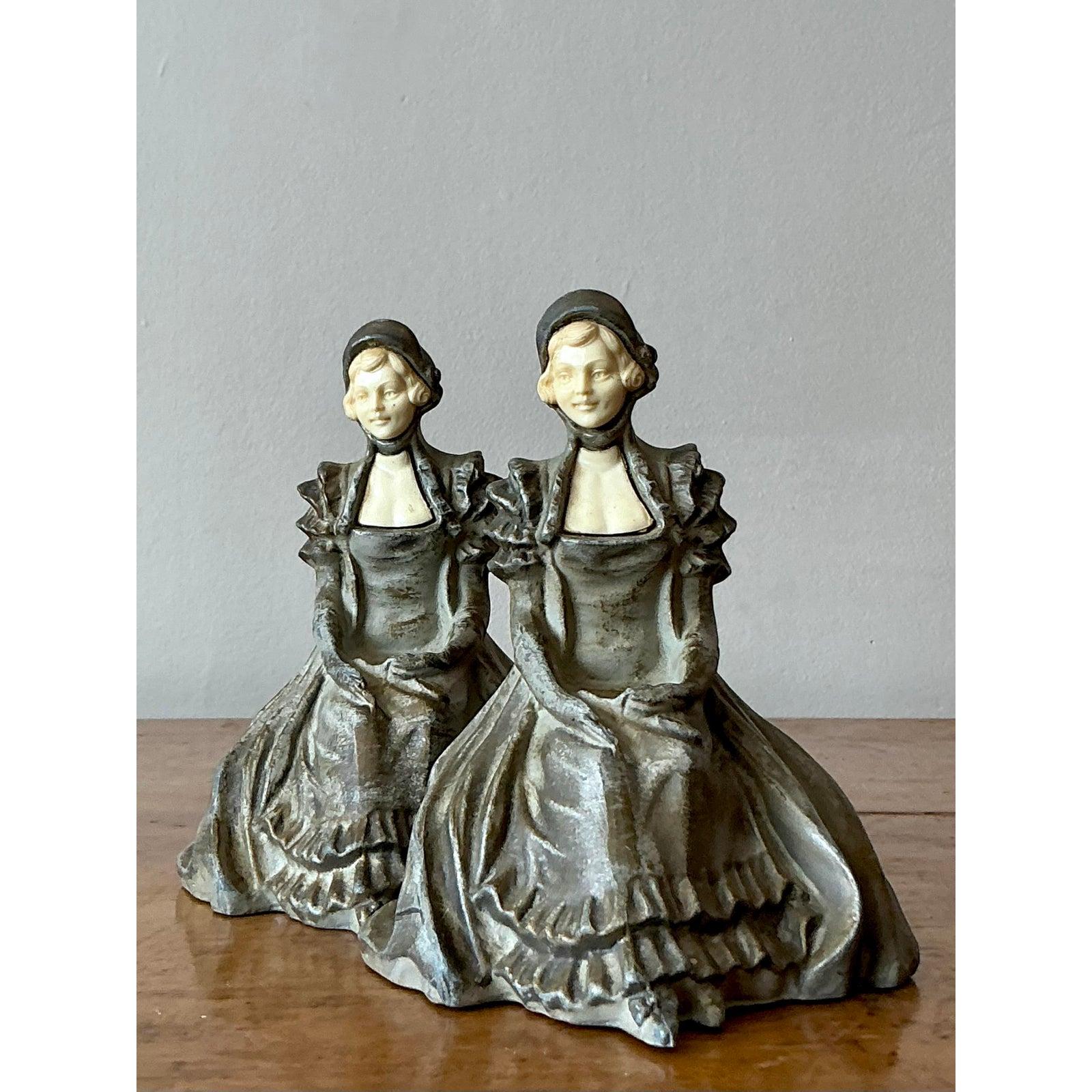 Add a touch of romantic, old-world charm to your library with this enchanting pair of vintage bookends. Each piece features a gracefully seated lady, her full, ruffled gown and bonnet masterfully rendered in a beautifully patinated dark metal. The