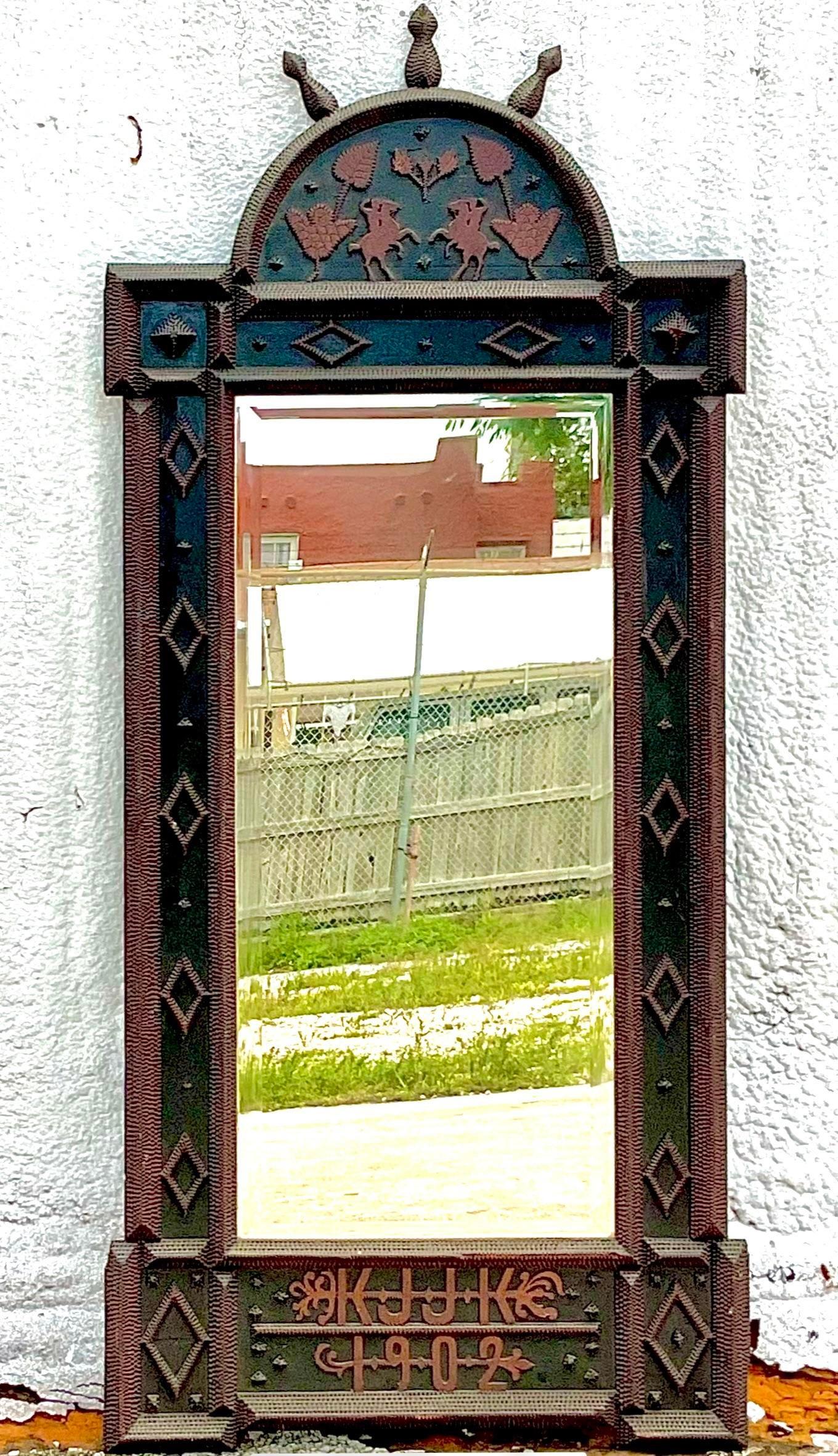 Incredible vintage Boho wall mirror. A striking Tramp Art mirror with vintage icons. Marked 1902 across the bottom. Acquired from a Palm Beach estate.