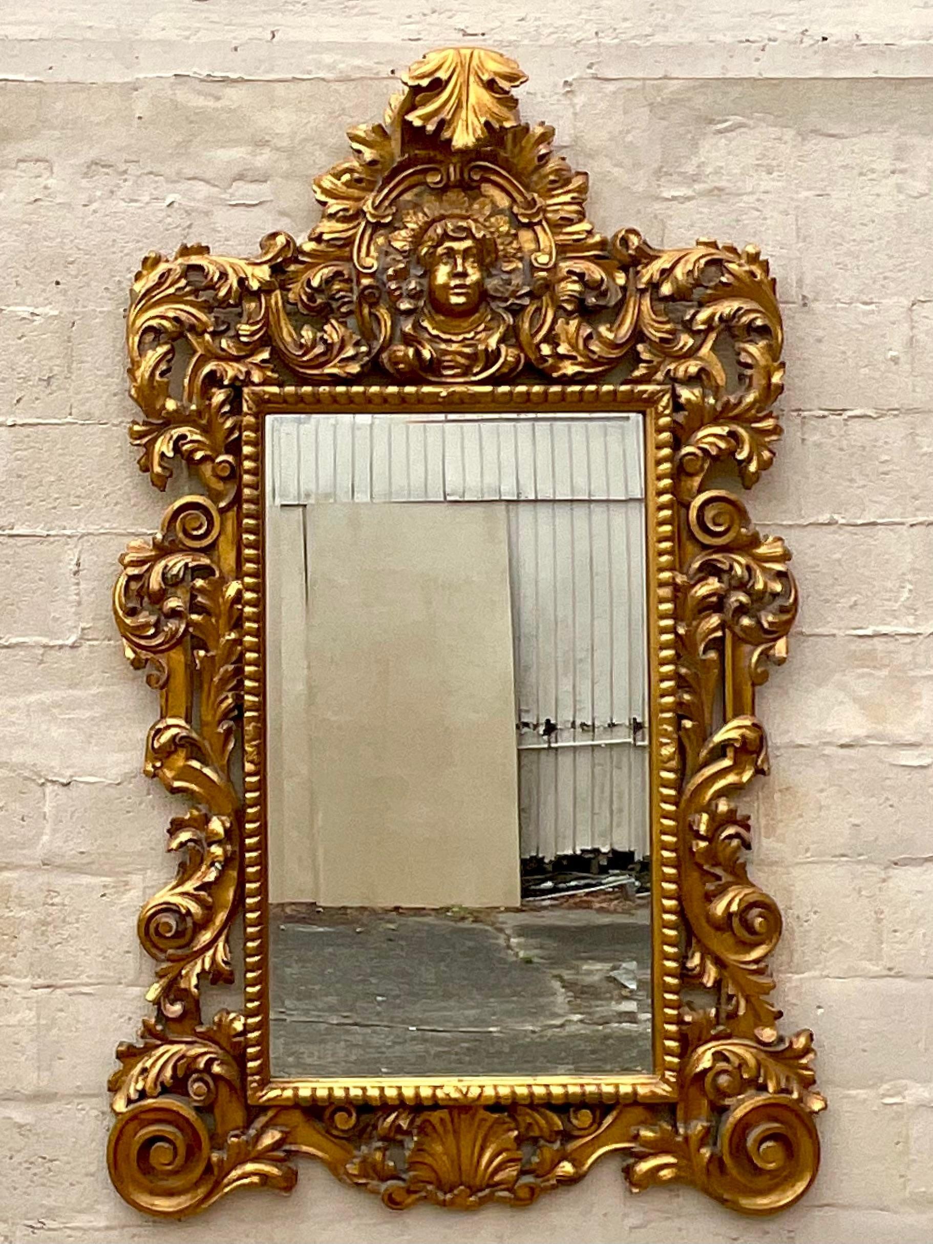 Trasforma il tuo spazio con il nostro specchio vintage boho monumentale intagliato e dorato. Questo tesoro americano è caratterizzato da intricati intagli e da una lussuosa finitura dorata, che fonde l'eleganza bohémien con uno stile grandioso.