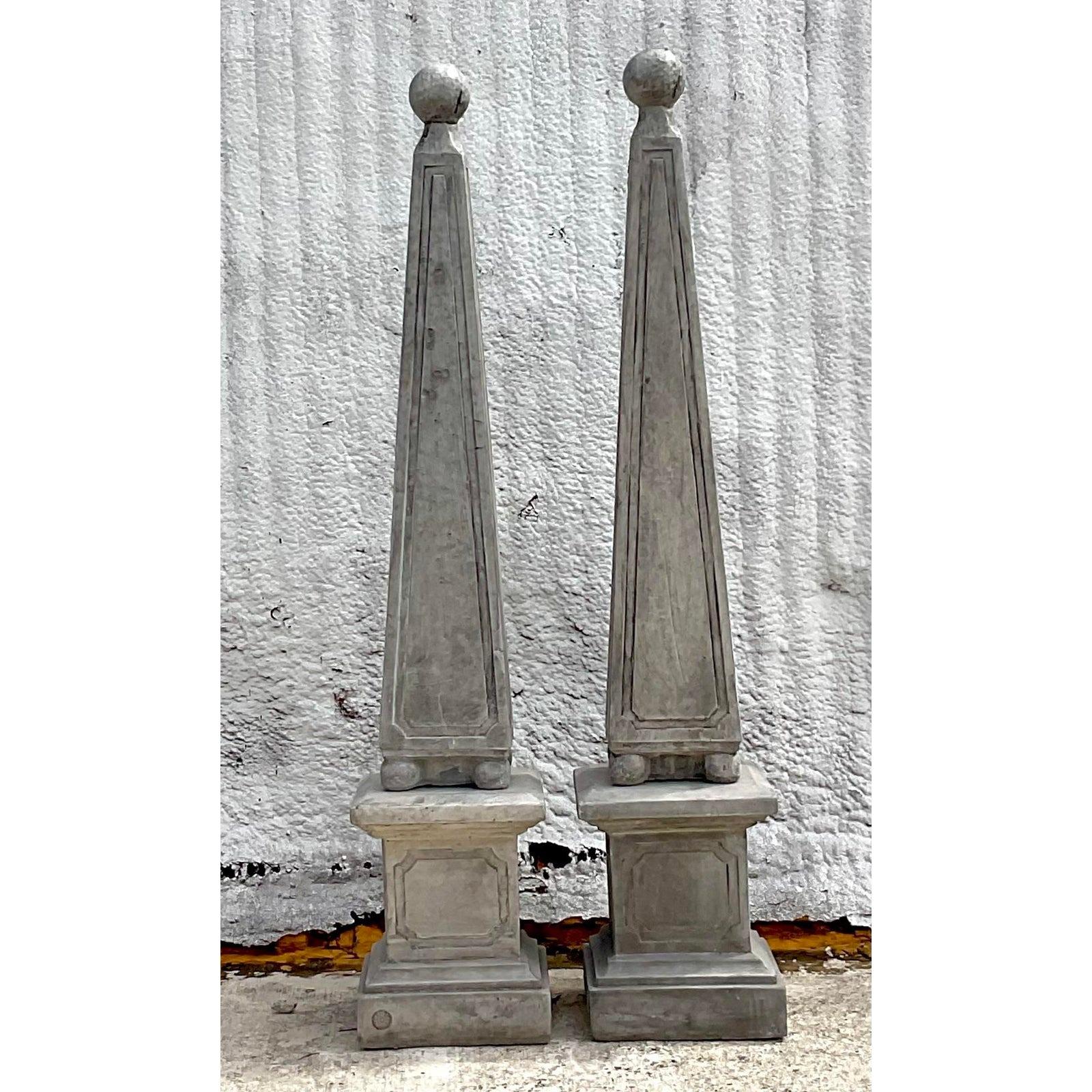 A stunning pair of vintage Monumental obelisks. Done in a pale grey cast concrete with beautiful attention to detail. Perfect at your garden entrance or on either side of your front door. You decide! Acquired from a Palm Beach estate.