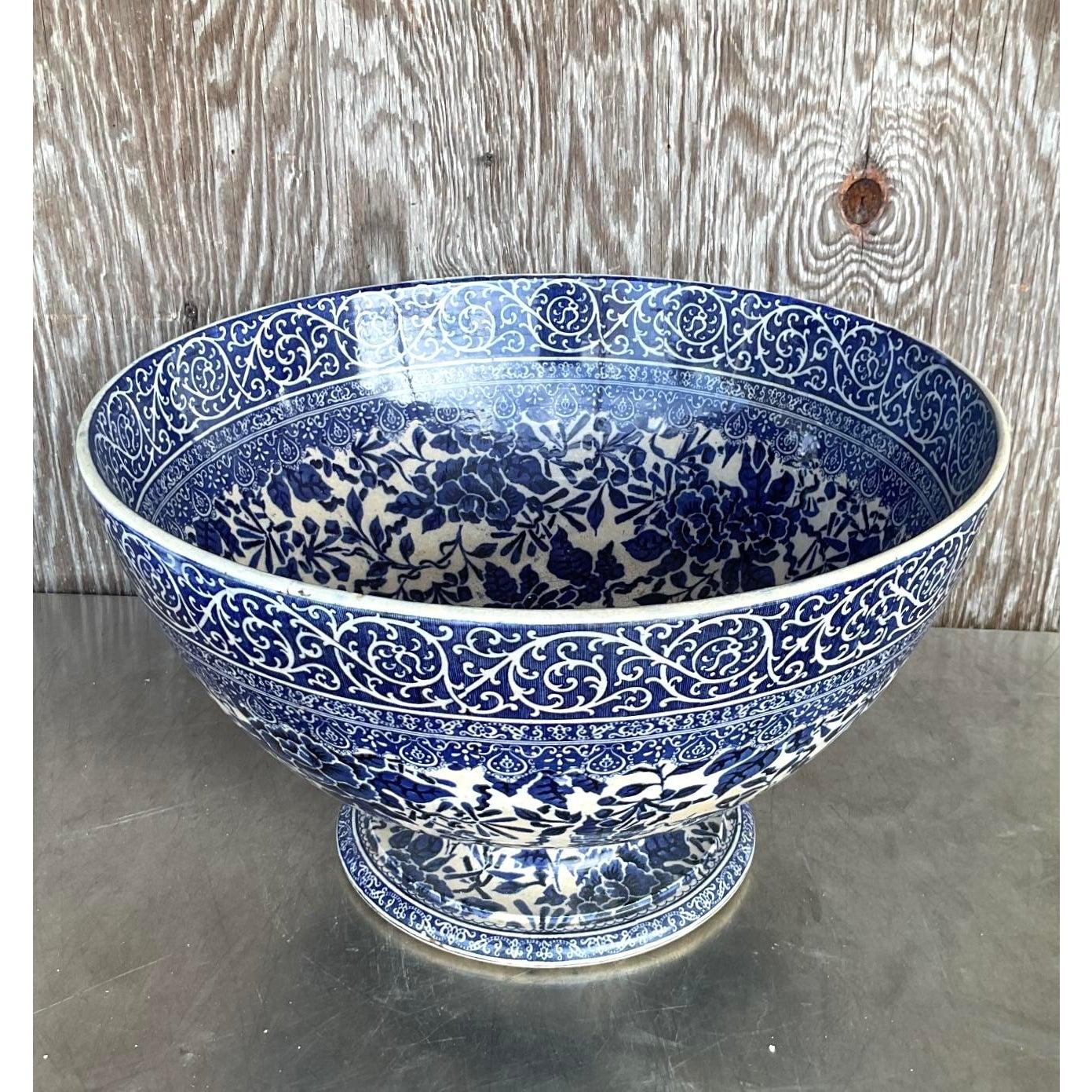 Make an elegant statement with this Vintage Boho Monumental Doulton Burslem Centerpiece Bowl, an extraordinary display of traditional English craftsmanship. Crafted by the renowned Doulton Burslem pottery house, this impressive footed bowl features