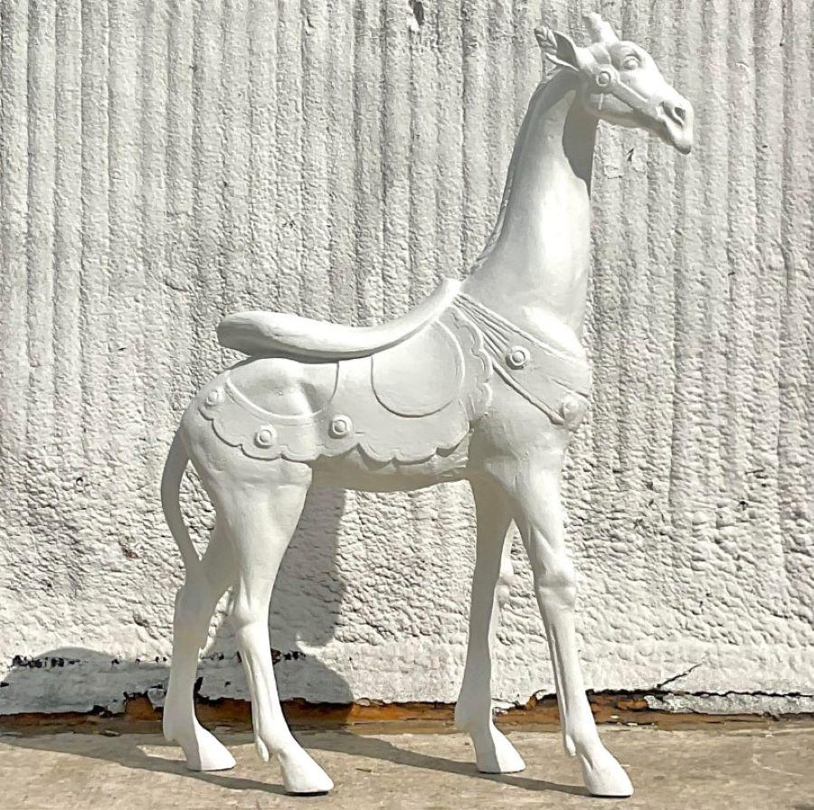 A fabulous vintage Boho giraffe. A monumental fella painted a plaster white. Made from a combination of plaster over wood. Acquired from a Palm Beach estate.