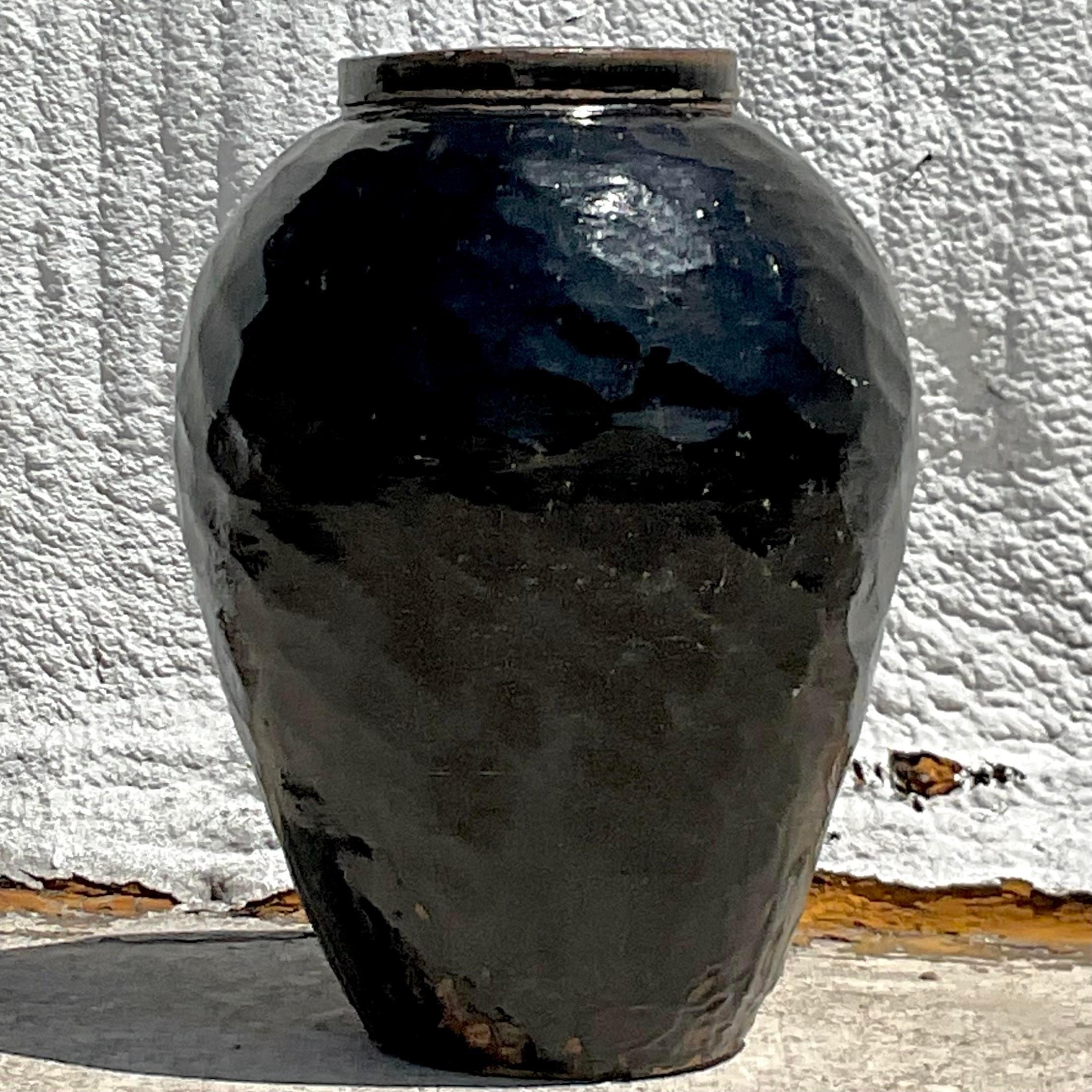 A fantastic vintage Boho planter. A chic glazed terracotta urn in a black glazed finish. A chic faceted design. Acquired from a NY estate.