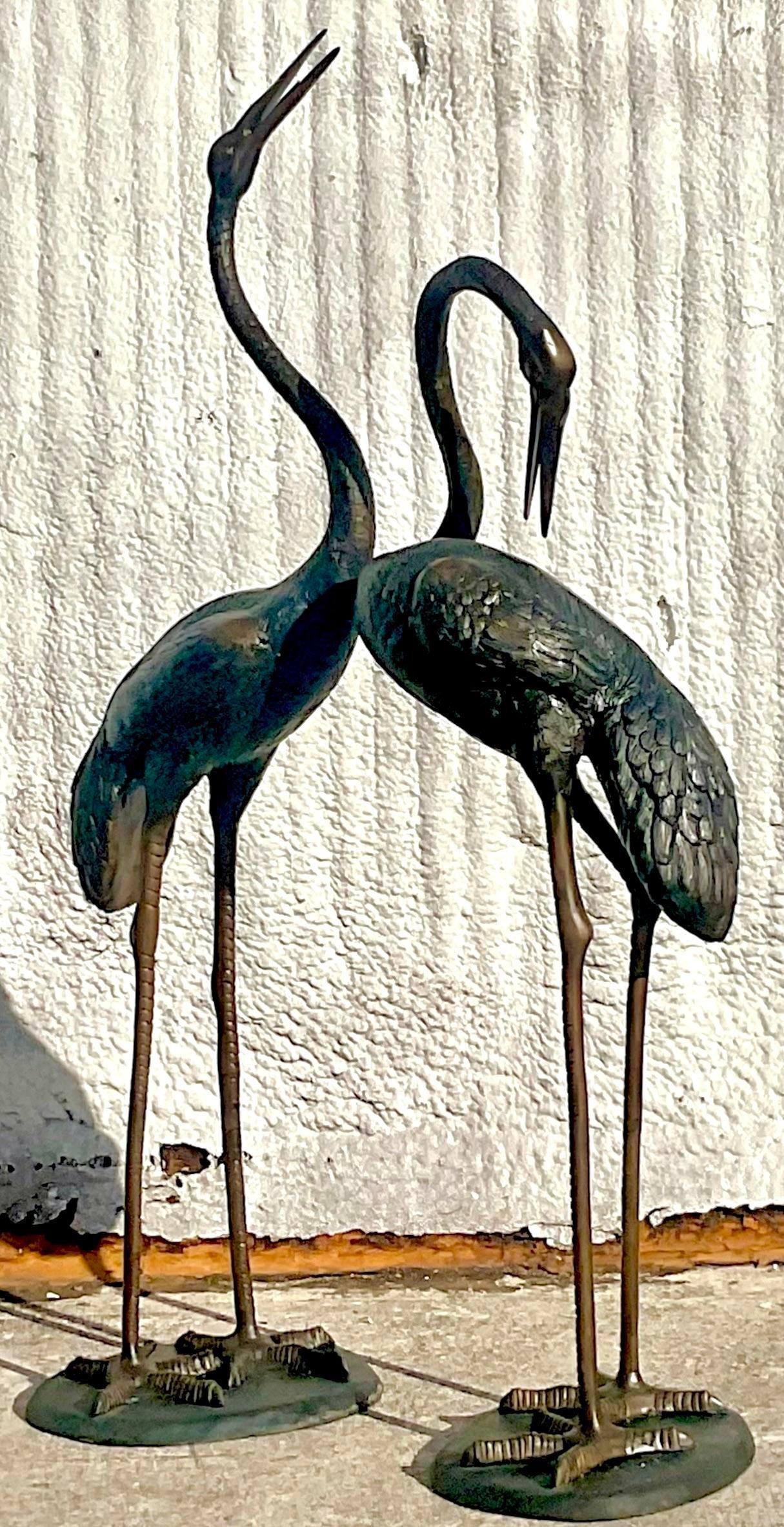 A stunning set of two vintage Cranes. Monumental in size and drama. Solid bronze construction with a beautiful patina from time. Perfect indoors our outdoors. You decide! Acquired from a Palm a each estate.

Lower crane 18x18x48