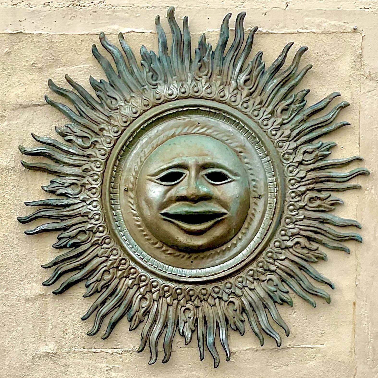 A spectacular vintage Sun wall sculpture. Chic patinated cast aluminum with beautiful attention to detail. Acquired from a Palm Beach estate.