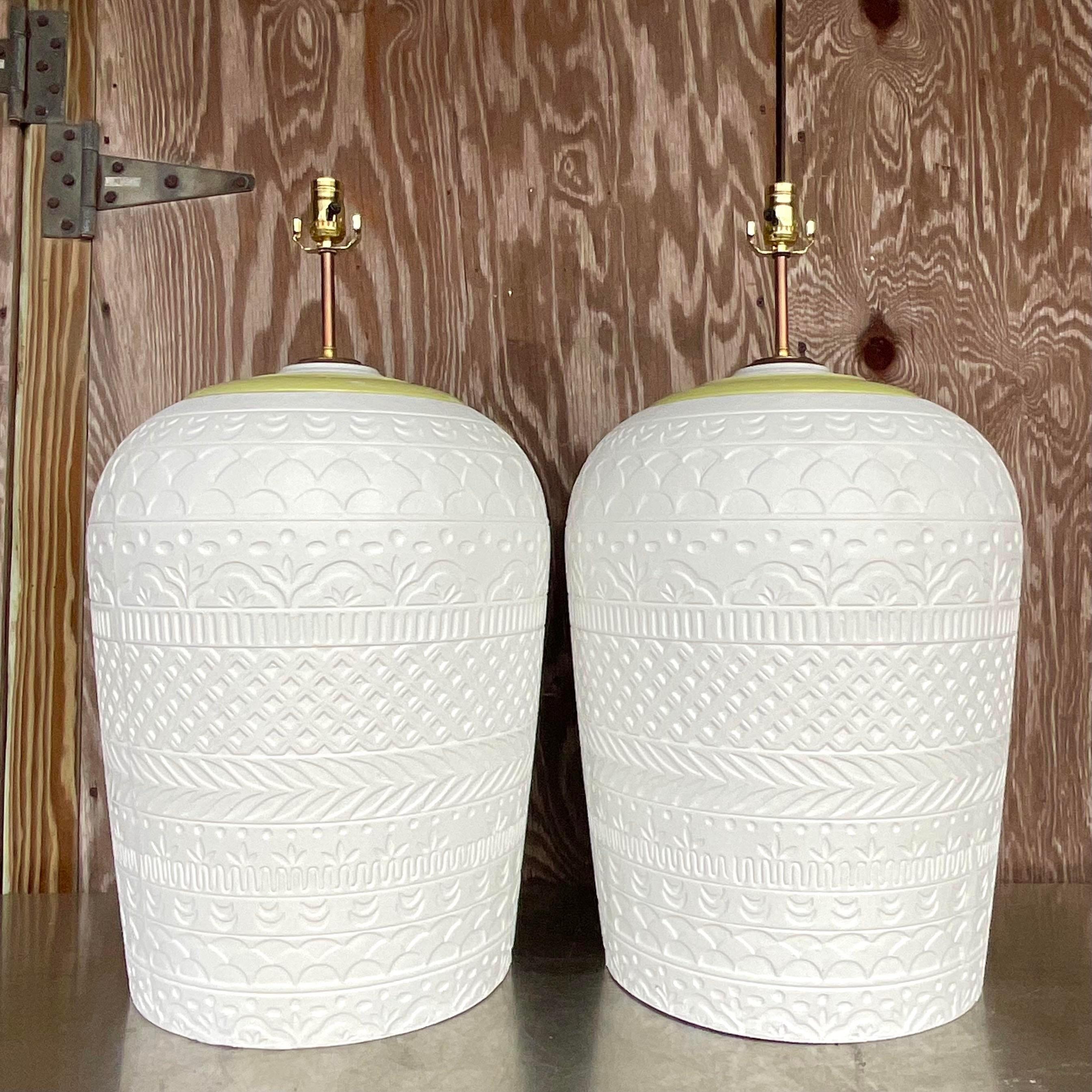 A fabulous pair of vintage Boho table lamps. A chic wrap around relief in plaster. Fully restored with all new wiring and hardware. Acquired from a Palm Beach estate