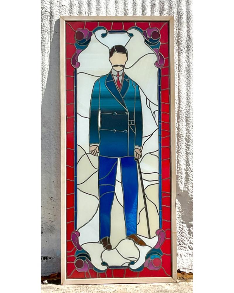 Step into an era of Bohemian charm with this Vintage Monumental Stained Glass Window featuring a striking depiction of a man. Illuminating any space with its vibrant hues and intricate details, it stands as a mesmerizing testament to the beauty of