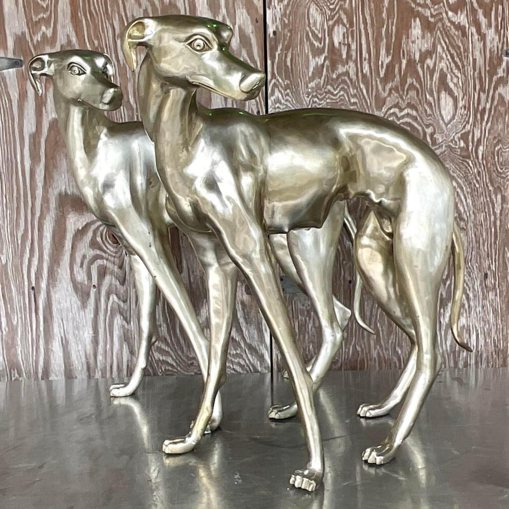 A striking pair of vintage Boho life size dogs. Chic white brass with a gorgeous matte finish. Tall and impressive. Acquired from a Palm Beach estate. 