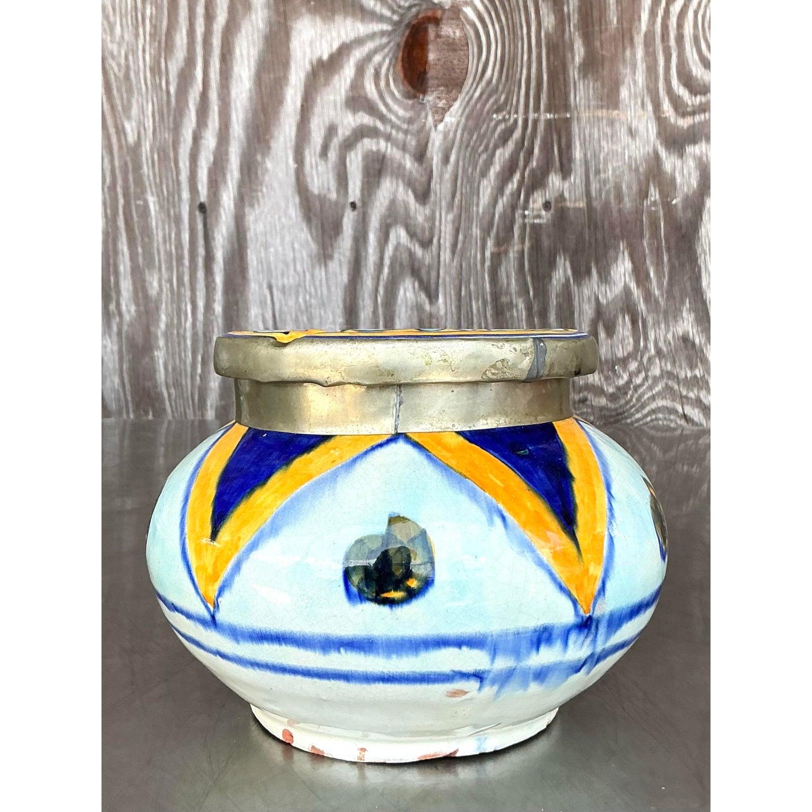 Infuse your space with global charm and artisanal flair with this vintage Boho Moroccan ashtray. Handcrafted in vibrant ceramic with hand-painted geometric designs in deep cobalt, golden saffron, and accents of earthy green, this piece reflects the