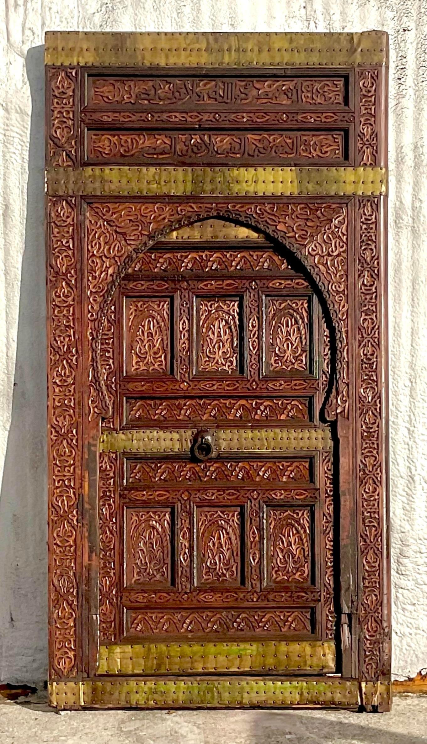 20th Century Vintage Boho Moroccan Carved Wooden Door With Brass Detail For Sale