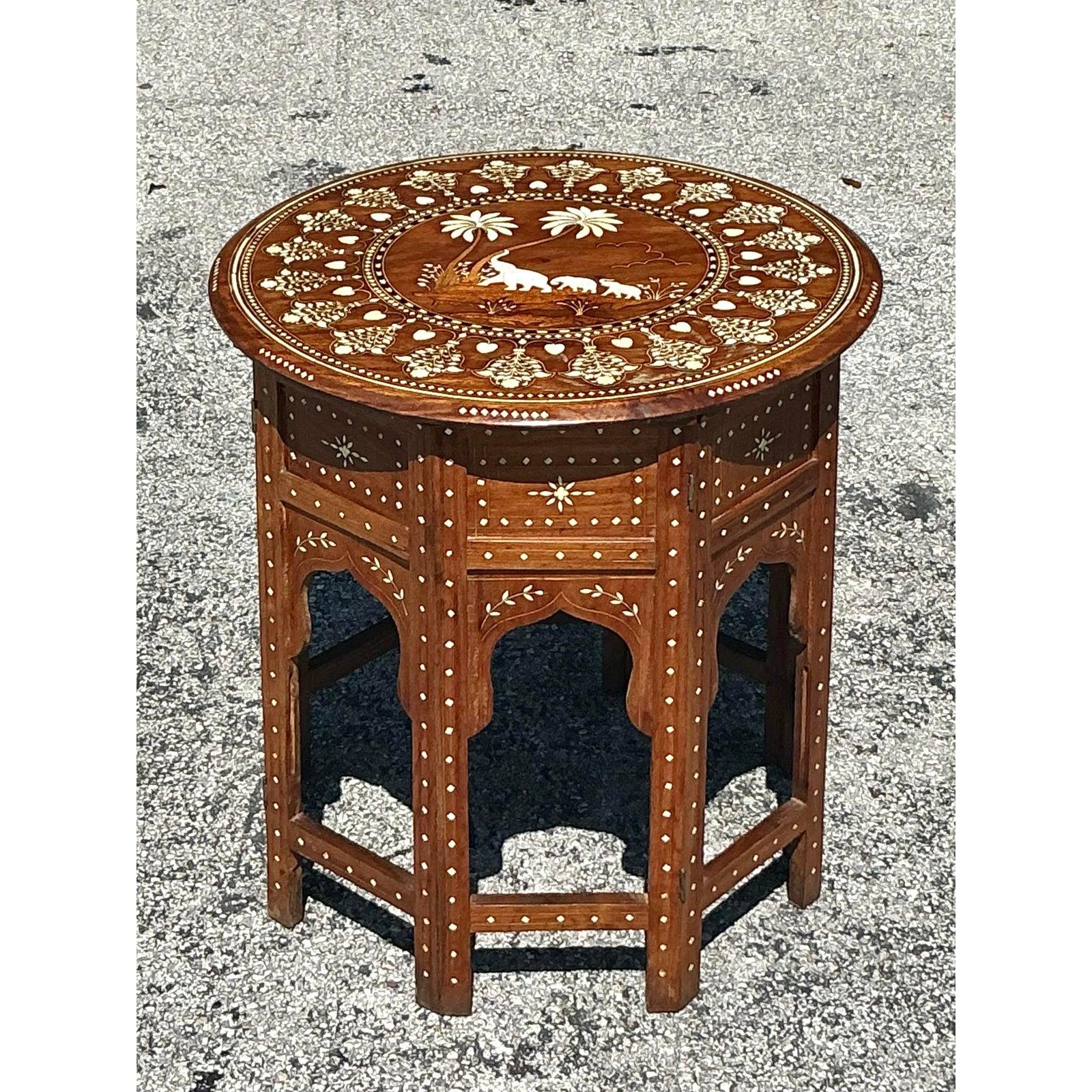 Introduce a touch of exotic wanderlust to your home with this charming Vintage Boho Elephant Inlay Side Table. Likely crafted with intricate inlay work, this piece probably features depictions of elephants and possibly other decorative motifs,