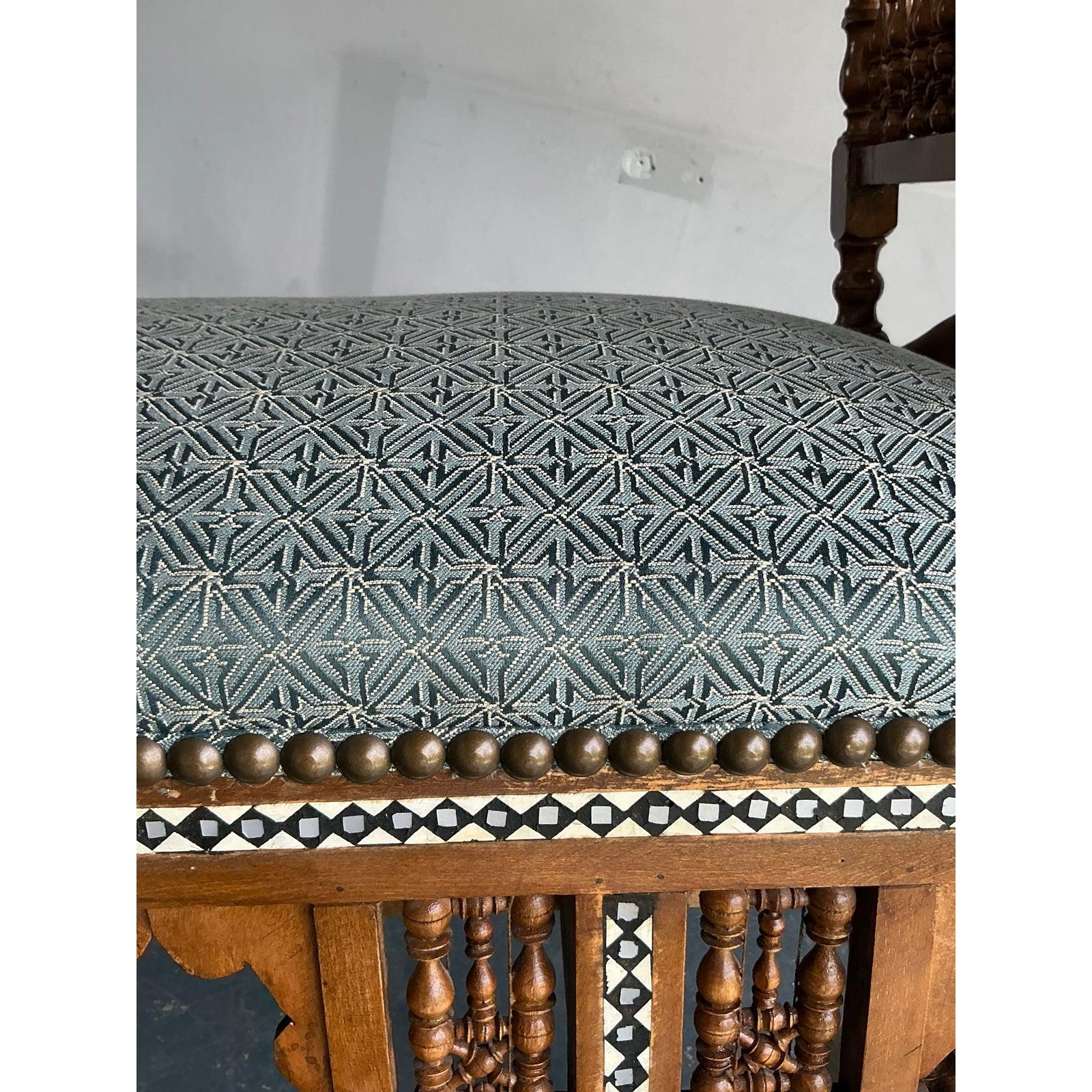 Presenting a truly captivating vintage Moroccan inlay wood bench, a piece that effortlessly marries bohemian flair with exquisite craftsmanship. This exceptional settee features intricate hand-carved detailing throughout its wooden frame, showcasing