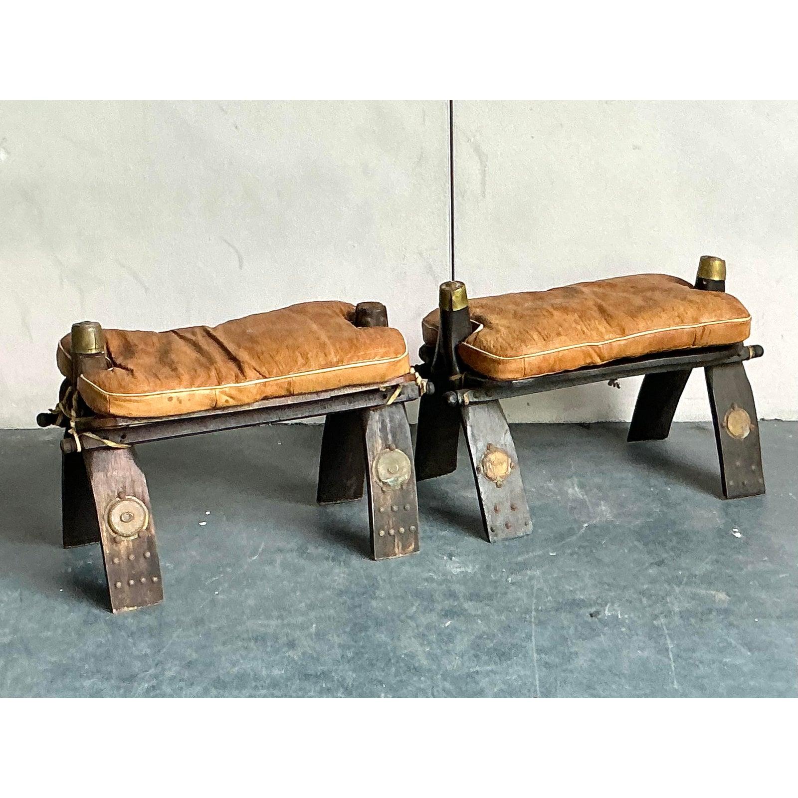 Imbue your home with the rich heritage and adventurous spirit of North Africa with this captivating set of four vintage Moroccan camel stools. Each piece is a unique work of art, meticulously crafted with hand-tooled leather in varying shades of