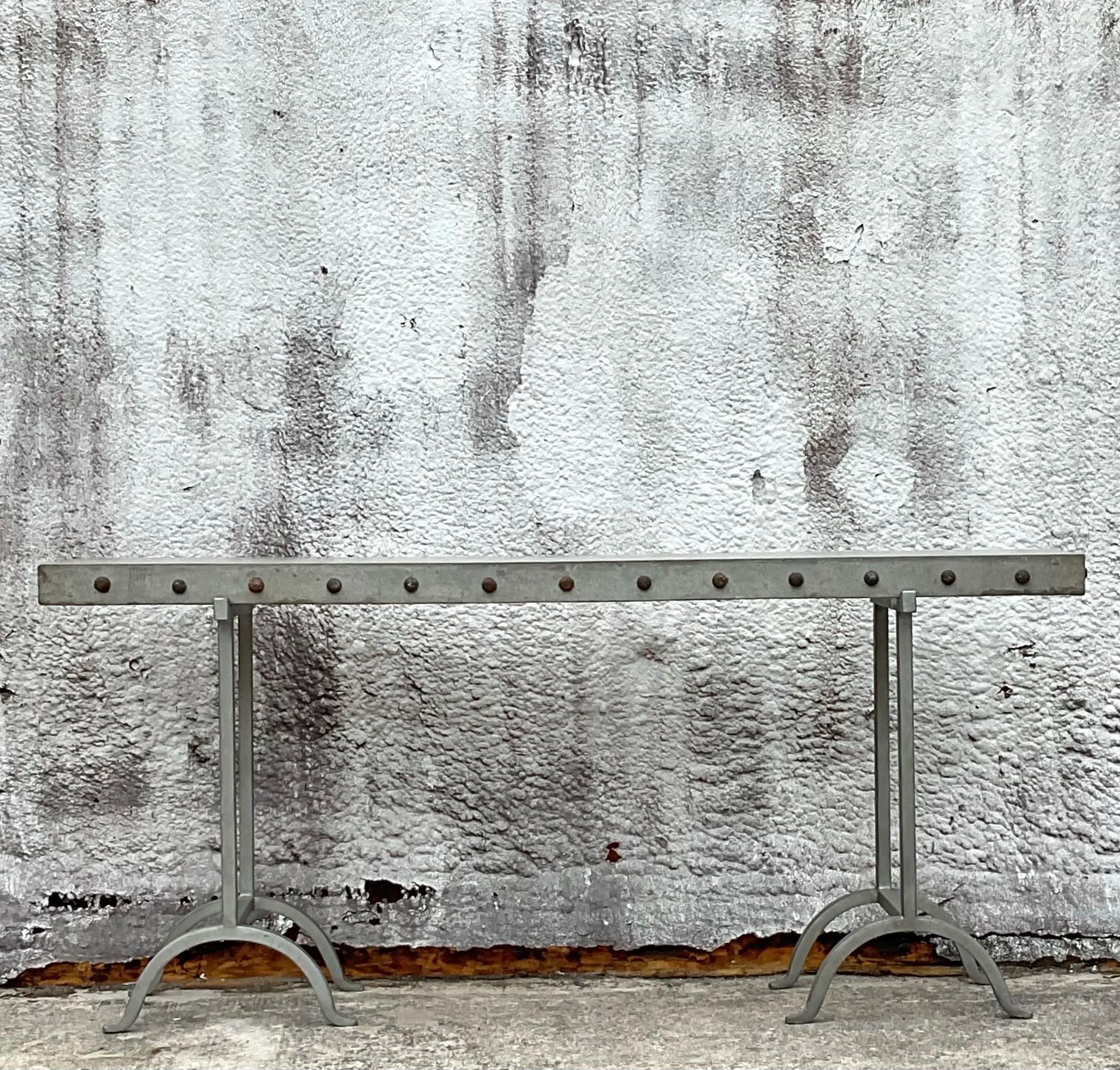 Make a bold statement with this Vintage Boho Nailhead Plaster Console Table. Featuring a striking plaster finish adorned with intricate nailhead detailing, this console table embodies bohemian sophistication. Its clean lines and artisanal design