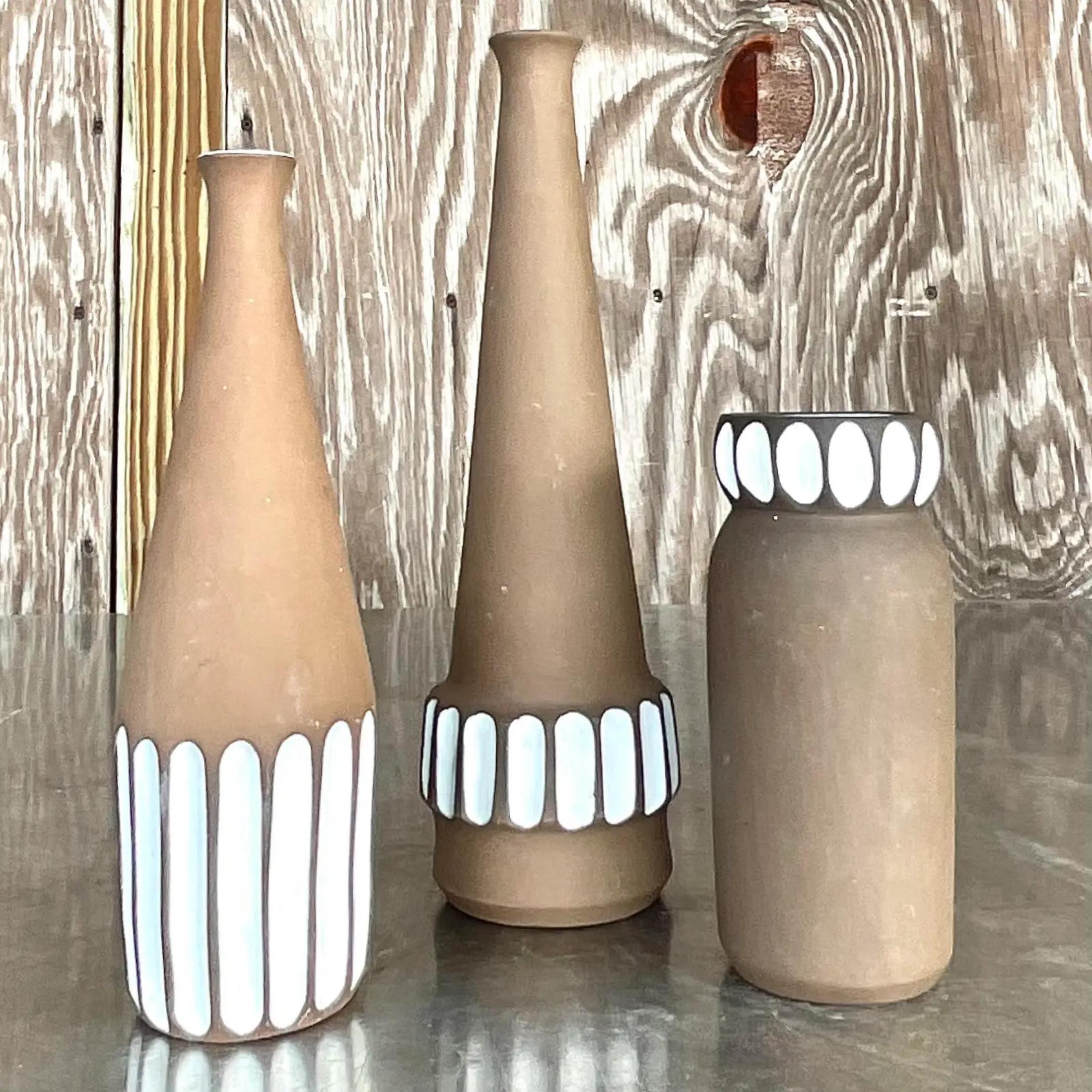 A fabulous trio of vintage Boho studio pottery vases. Made in Norway and signed on the bottom. A beautiful matte brown finish with a ring of glazed white impressions. Acquired from a Palm Beach estate.