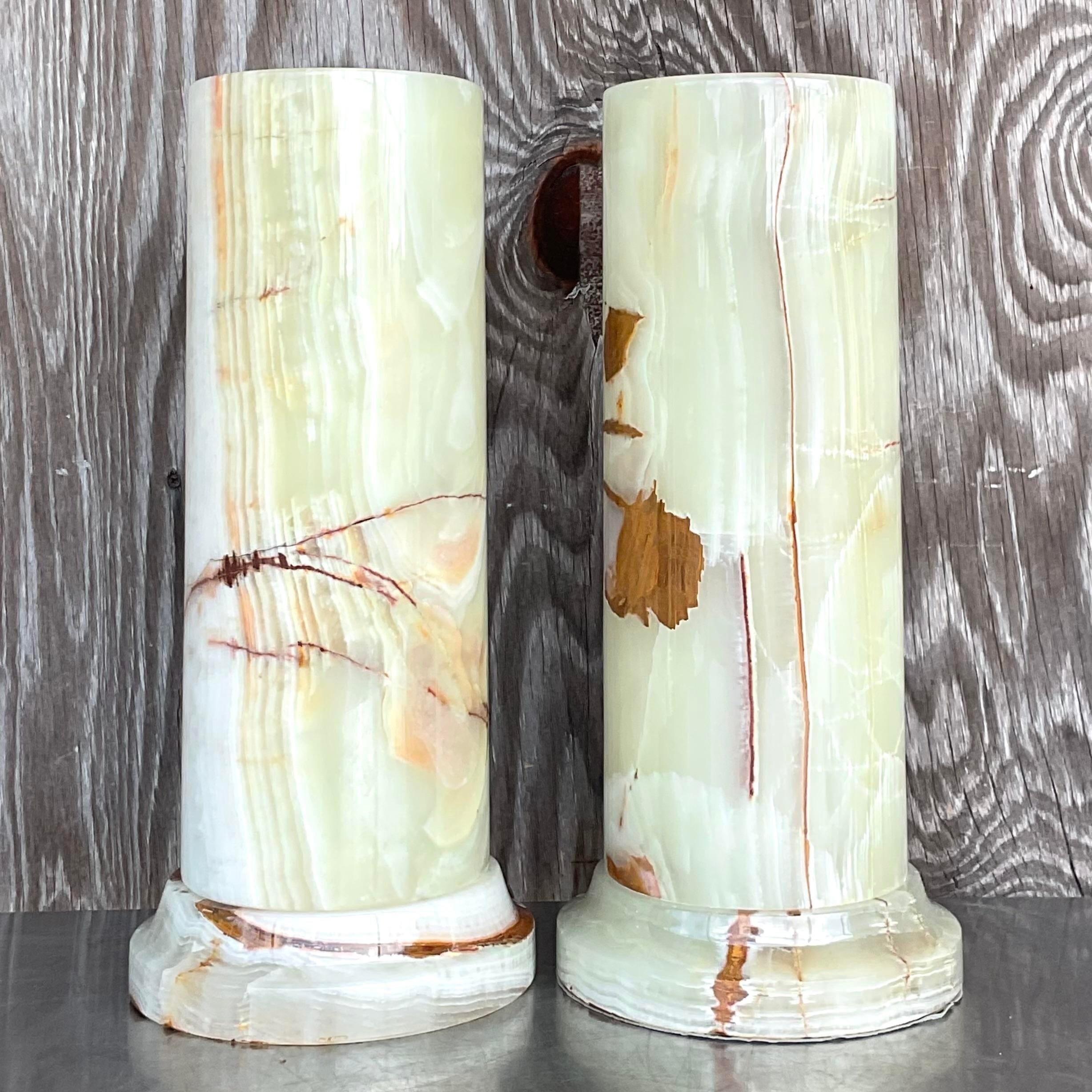 A stunning pair of vintage Boho table lamps. A chic Onyx cylinder design resting on a matching Onyx plinth. Acquired from a Palm Beach estate.
