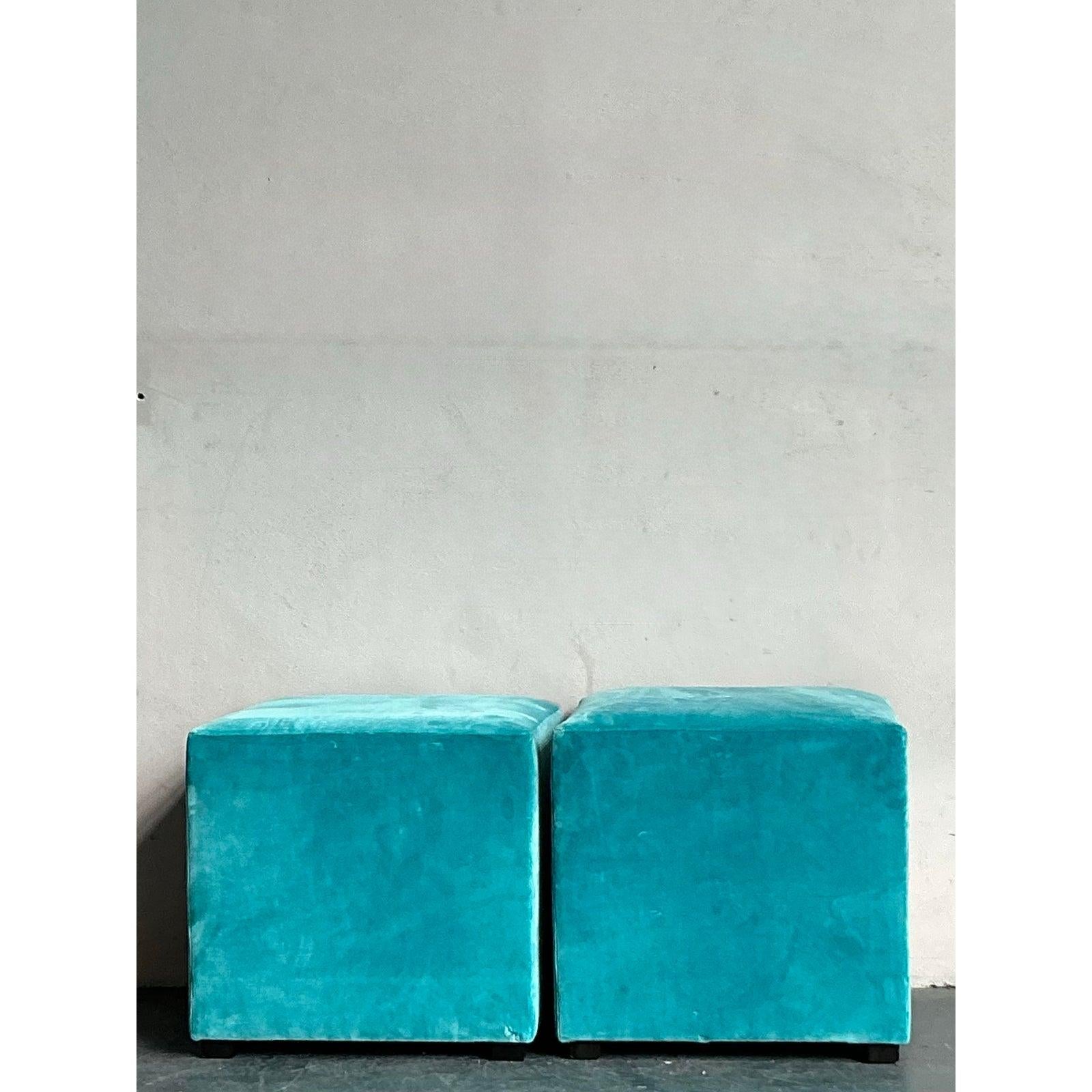 Introduce a touch of luxurious comfort and versatile style with this elegant pair of vintage cube ottomans, reminiscent of the iconic 