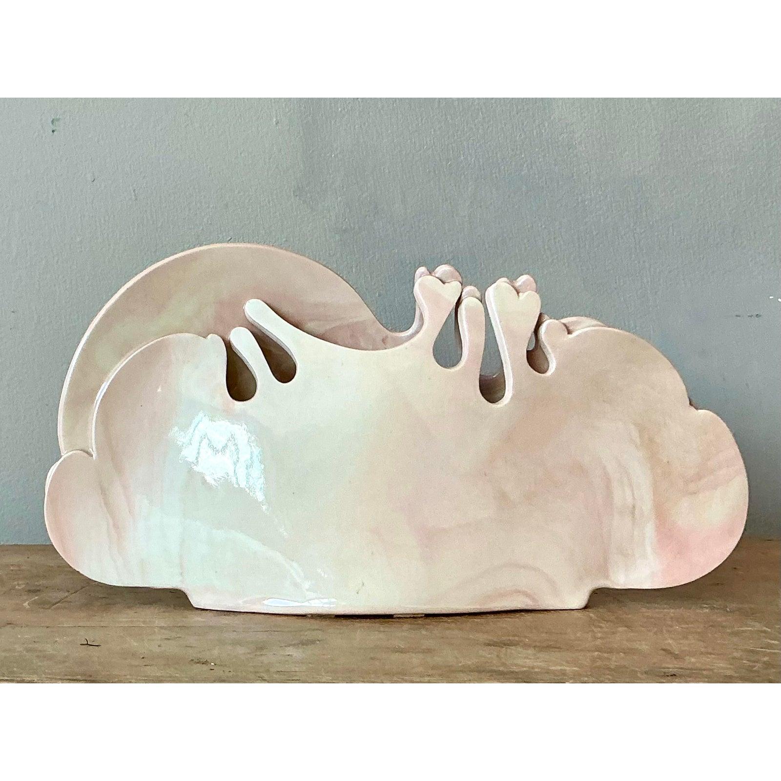 Trasmetti l'estetica eterea e sognante del movimento postmoderno degli anni '80 con questo accattivante portacarte o portatovaglioli in ceramica. Il pezzo presenta un design scultoreo a doppia parete modellato in nuvole stilizzate e svolazzanti,